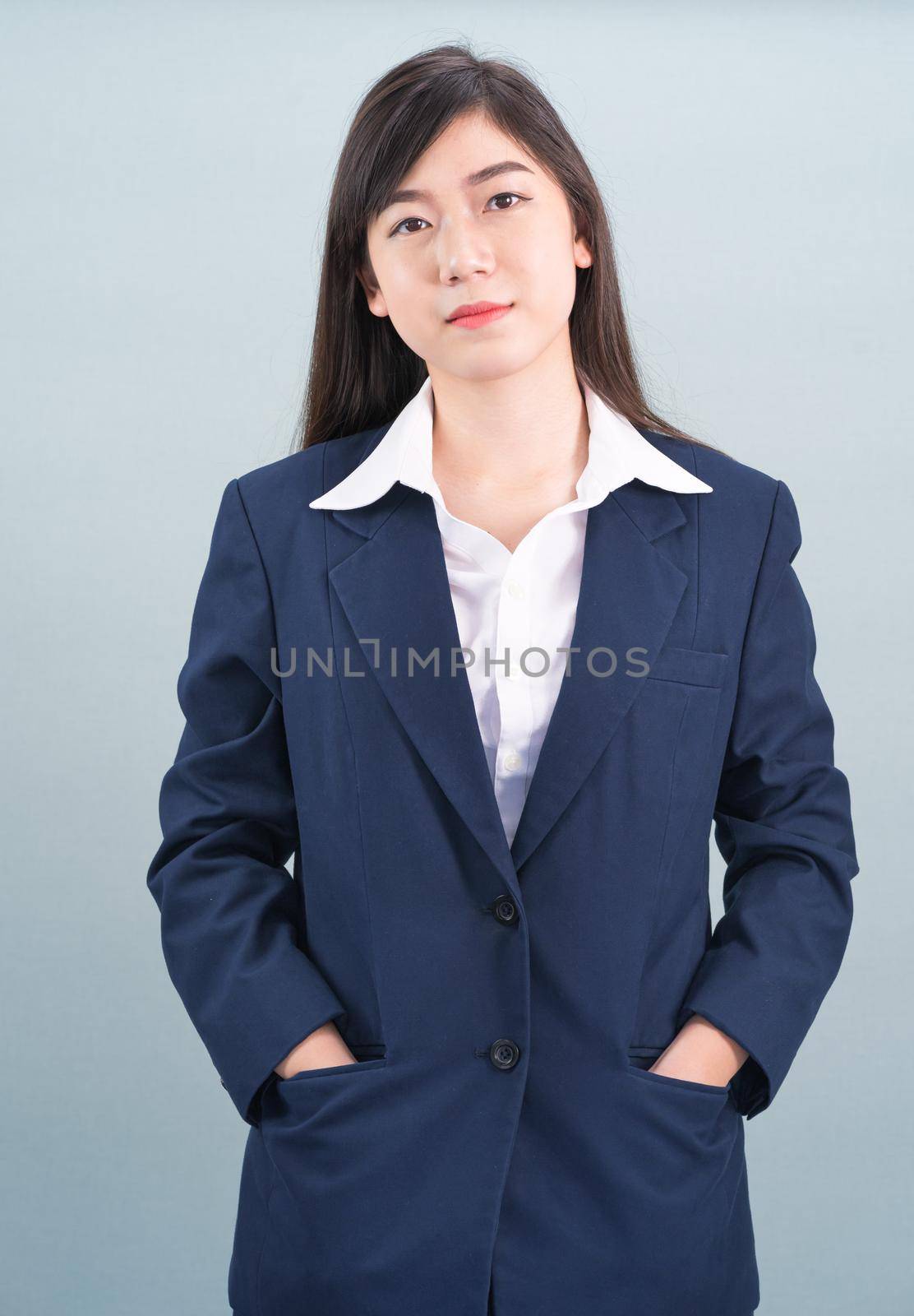 Portrait of asian businesswoman isolated on gray by stoonn