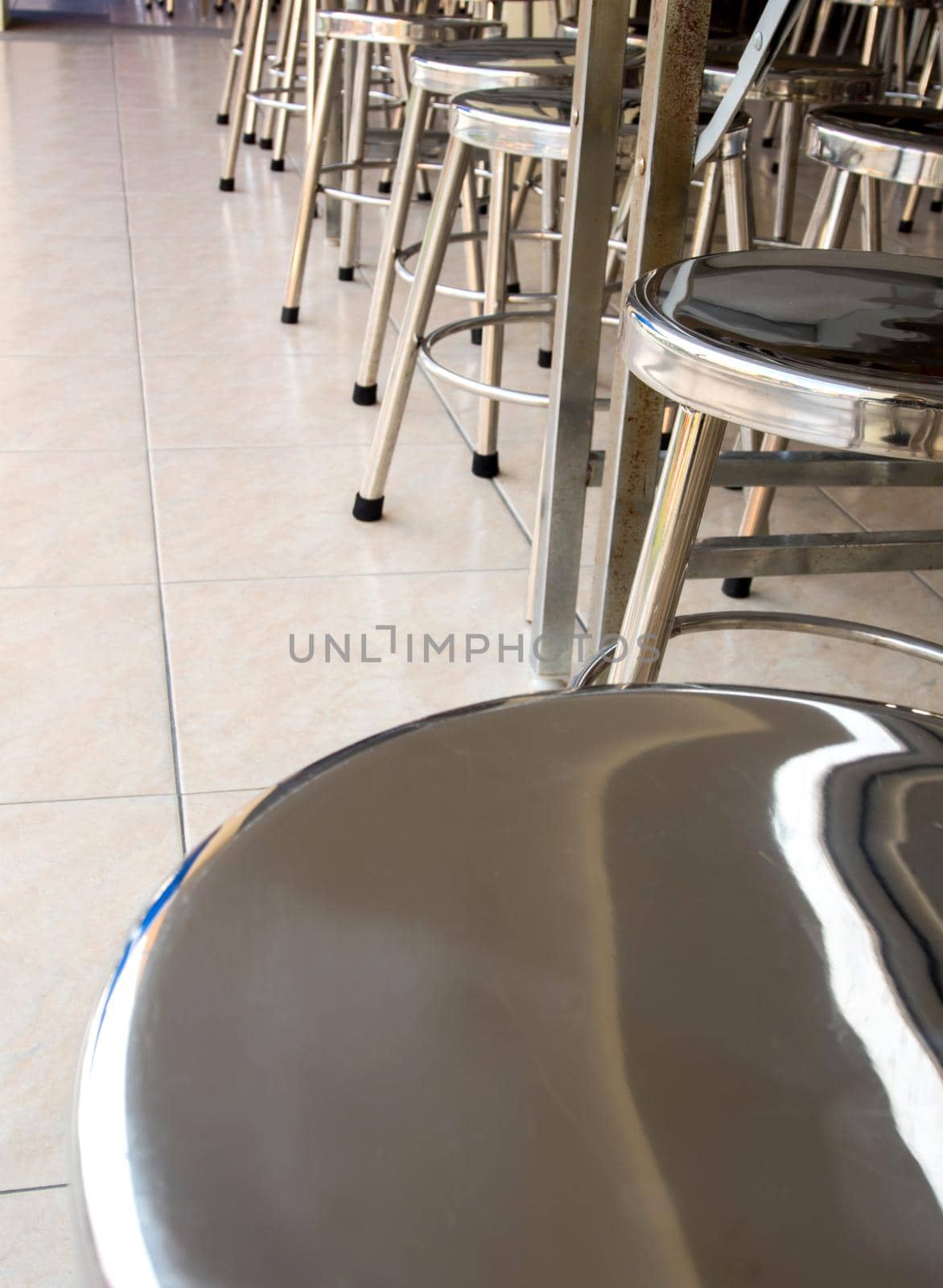 Stainless steel stool in school cafeteria by Satakorn