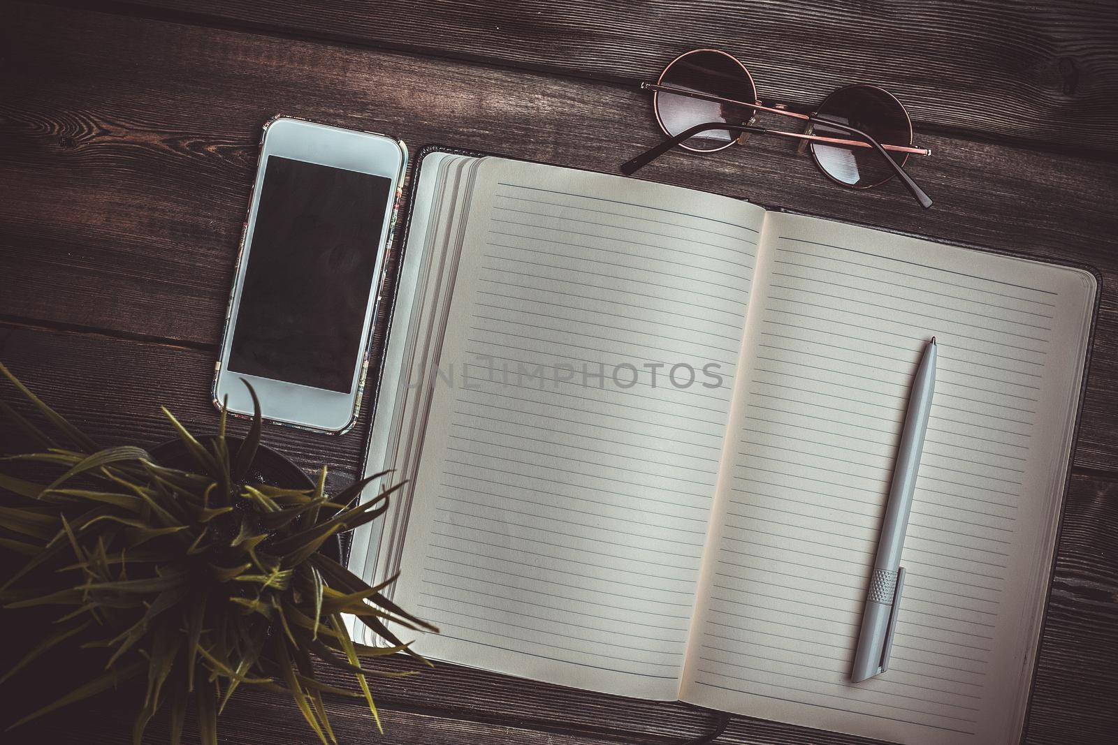 notebook with pen work desk sunglasses phone technology. High quality photo