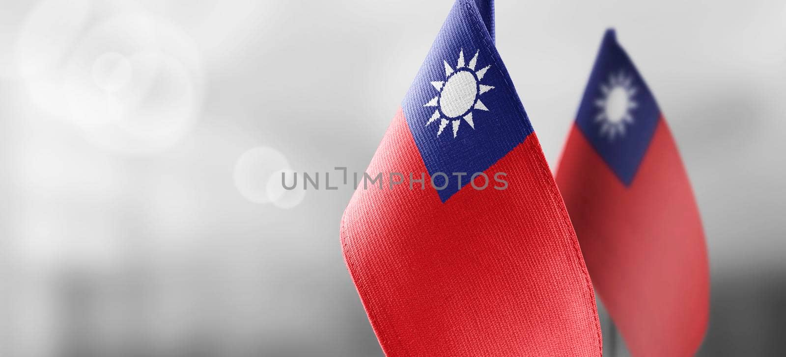 Small national flags of the Taiwan on a light blurry background.