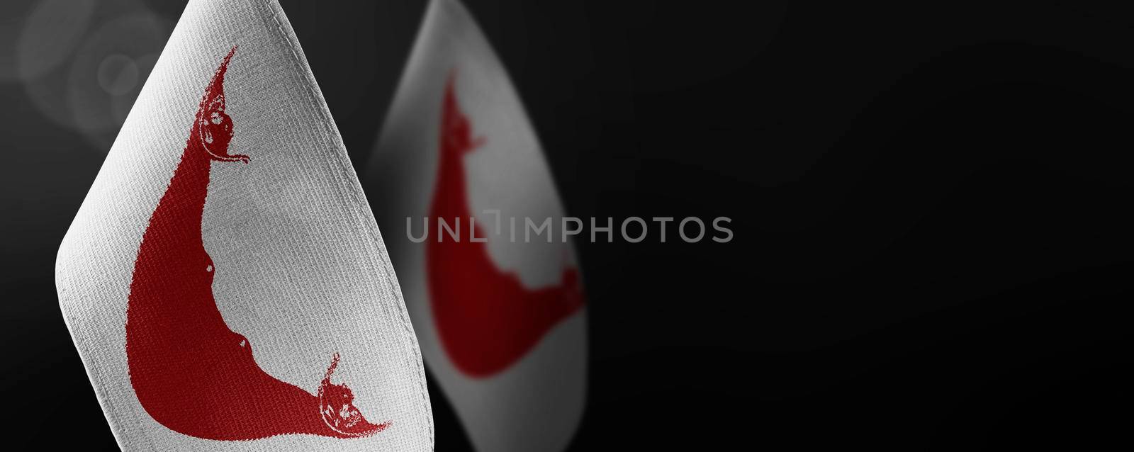 Small national flags of the Easter Island on a dark background.