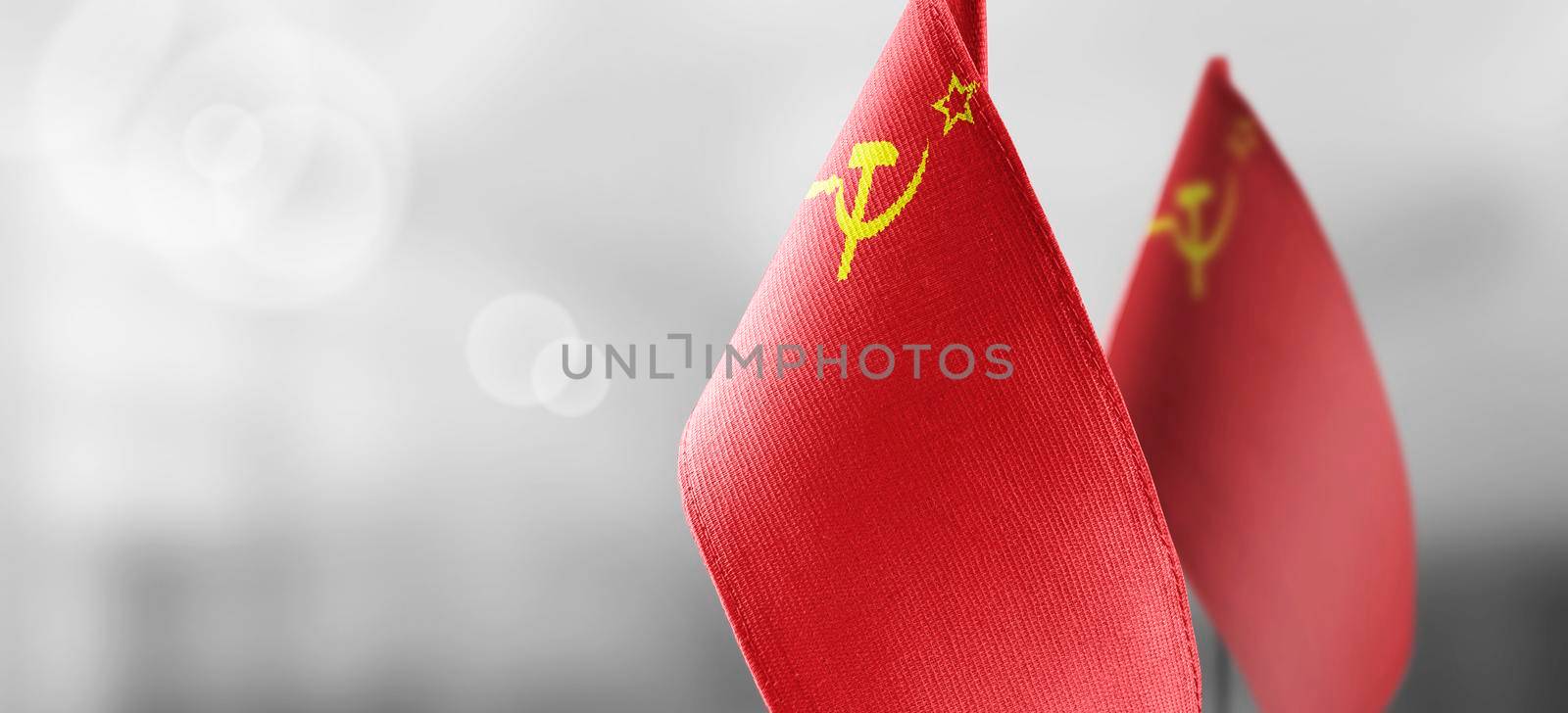 Small national flags of the USSR on a light blurry background.