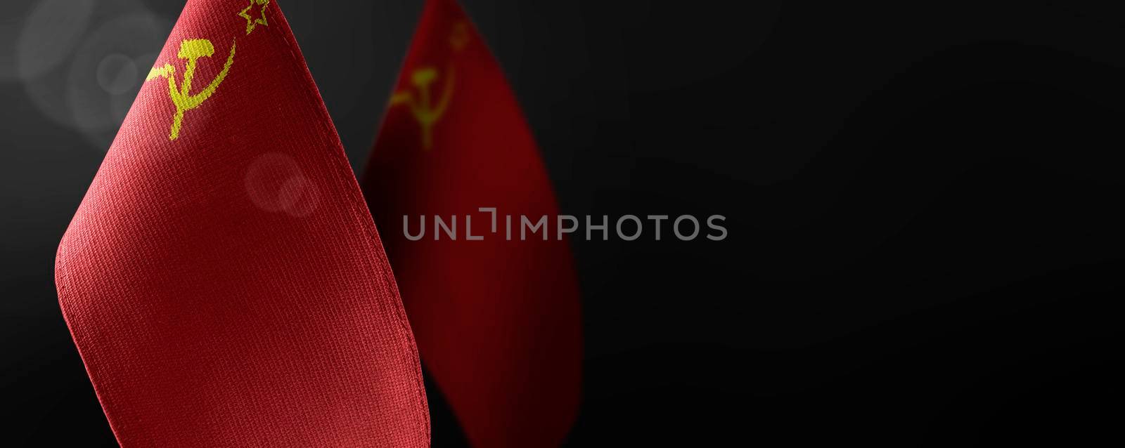 Small national flags of the USSR on a dark background by butenkow