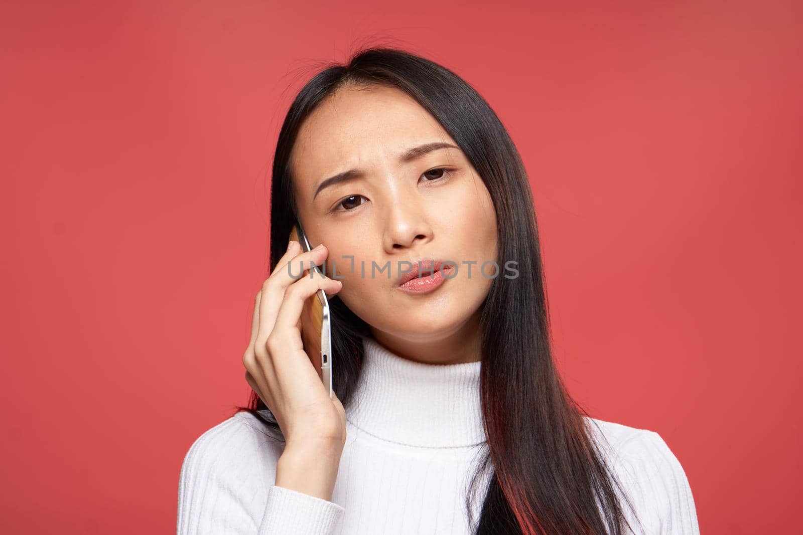 national woman talking on the phone technology studio red isolated background. High quality photo