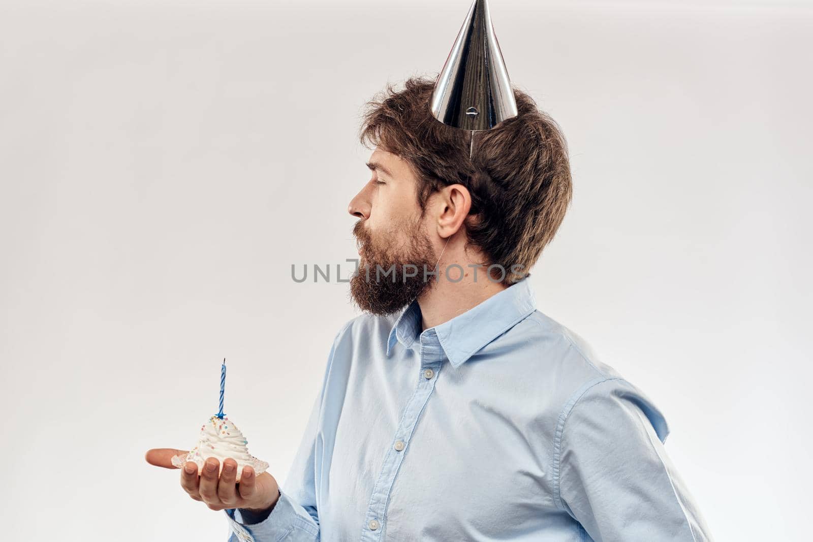 Happy guy with birthday cake white background Compact corporate party cropped beard view. High quality photo