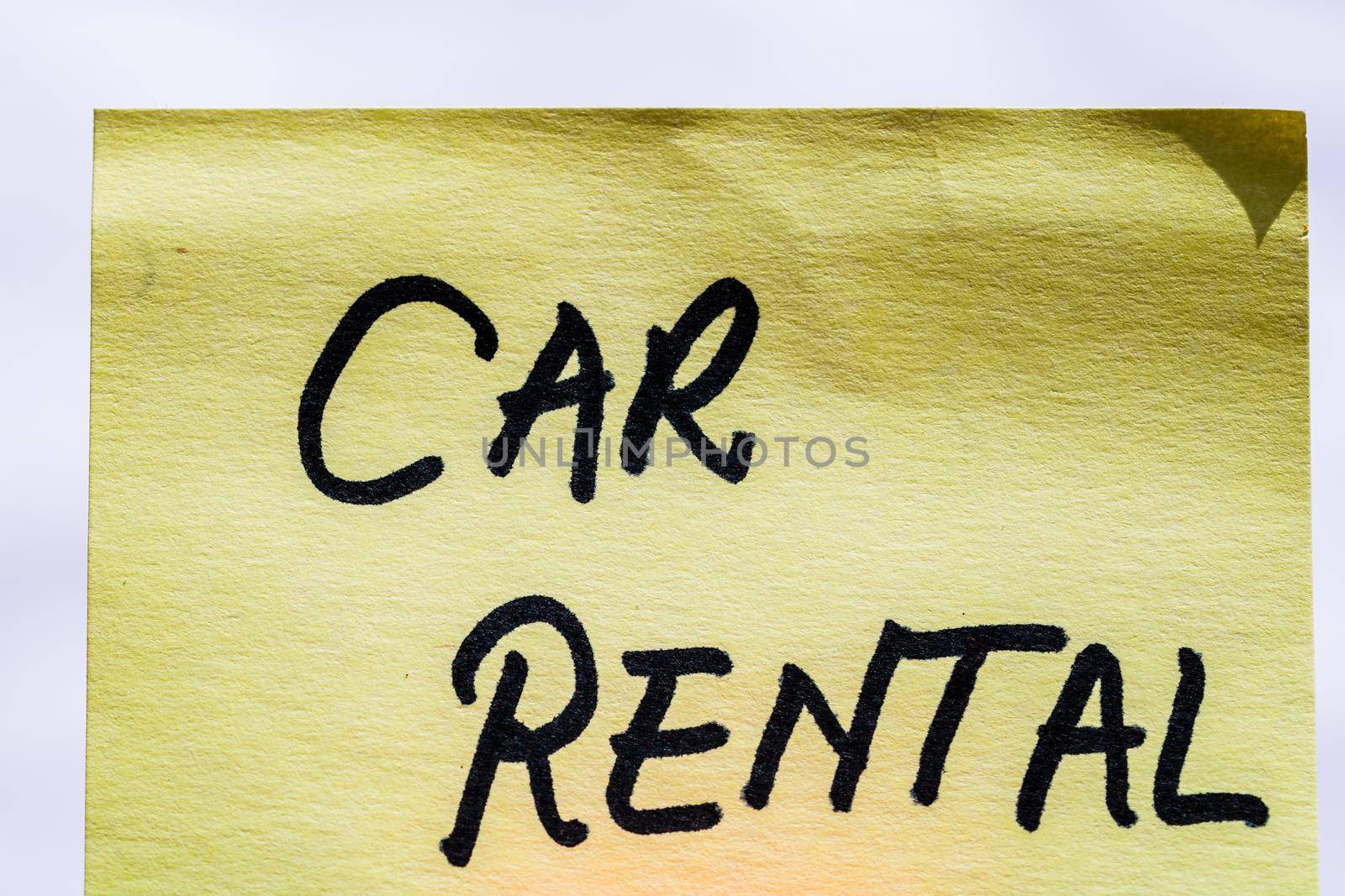 Rent car handwriting text close up isolated on yellow paper with copy space. by vladispas