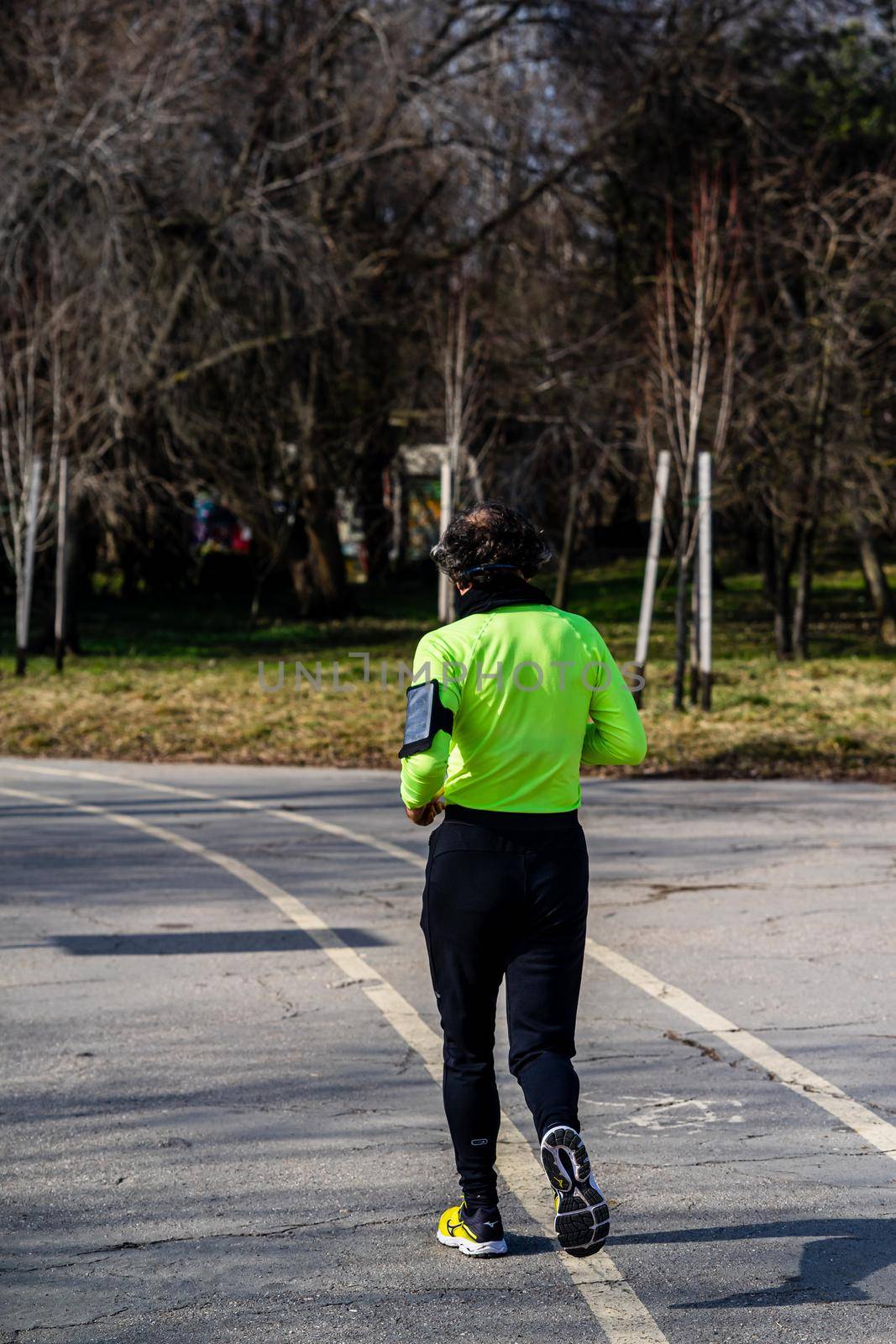 Jogging, running in the city park. Healthy lifestyle, outdoor physical activity and fitness concept in Bucharest, Romania, 2021