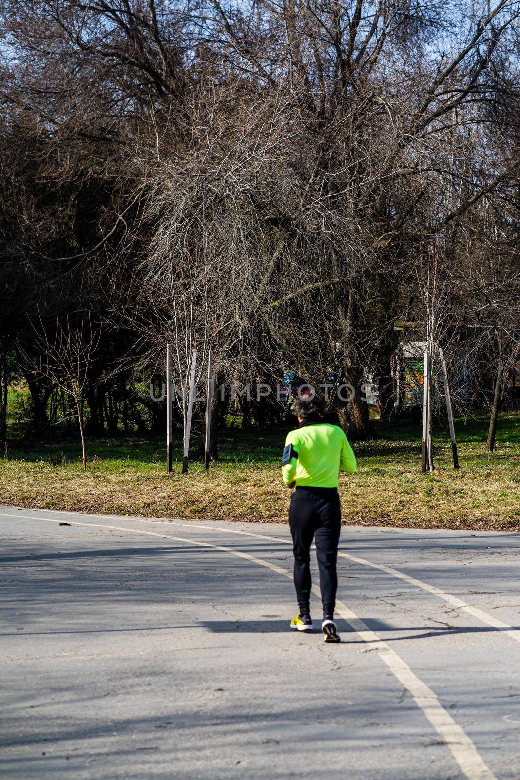 Jogging, running in the city park. Healthy lifestyle, outdoor physical activity and fitness concept in Bucharest, Romania, 2021