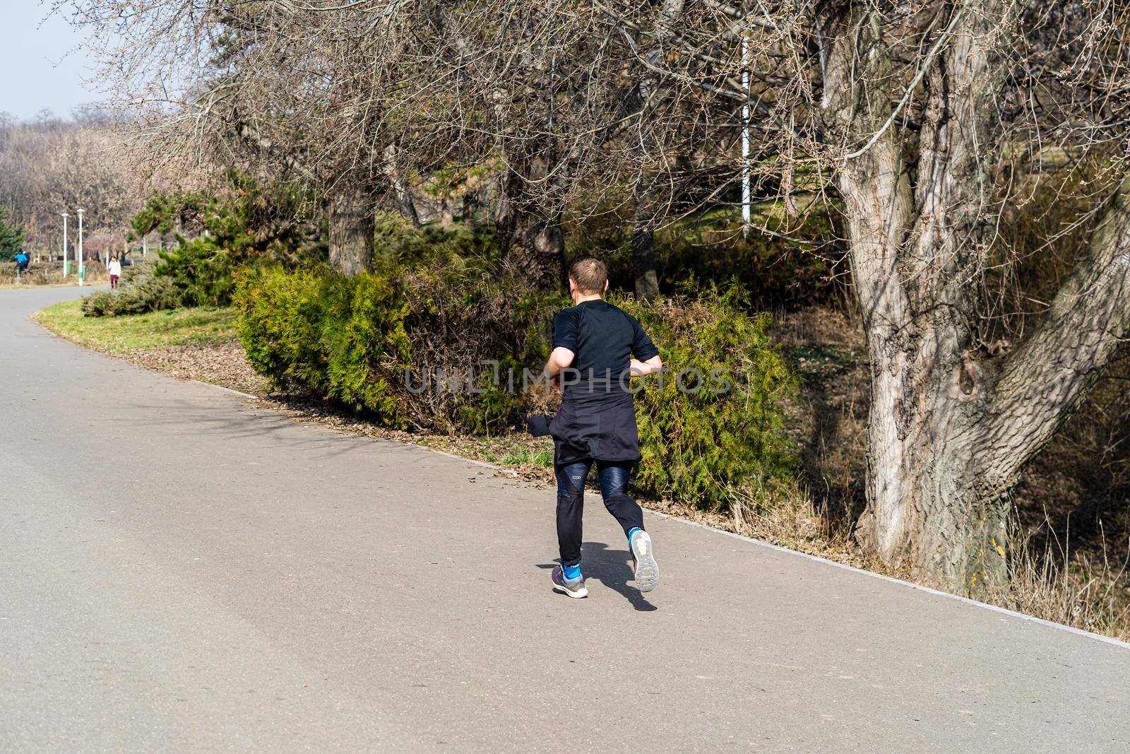 Jogging, running in the city park. Healthy lifestyle, outdoor physical activity and fitness concept in Bucharest, Romania, 2021