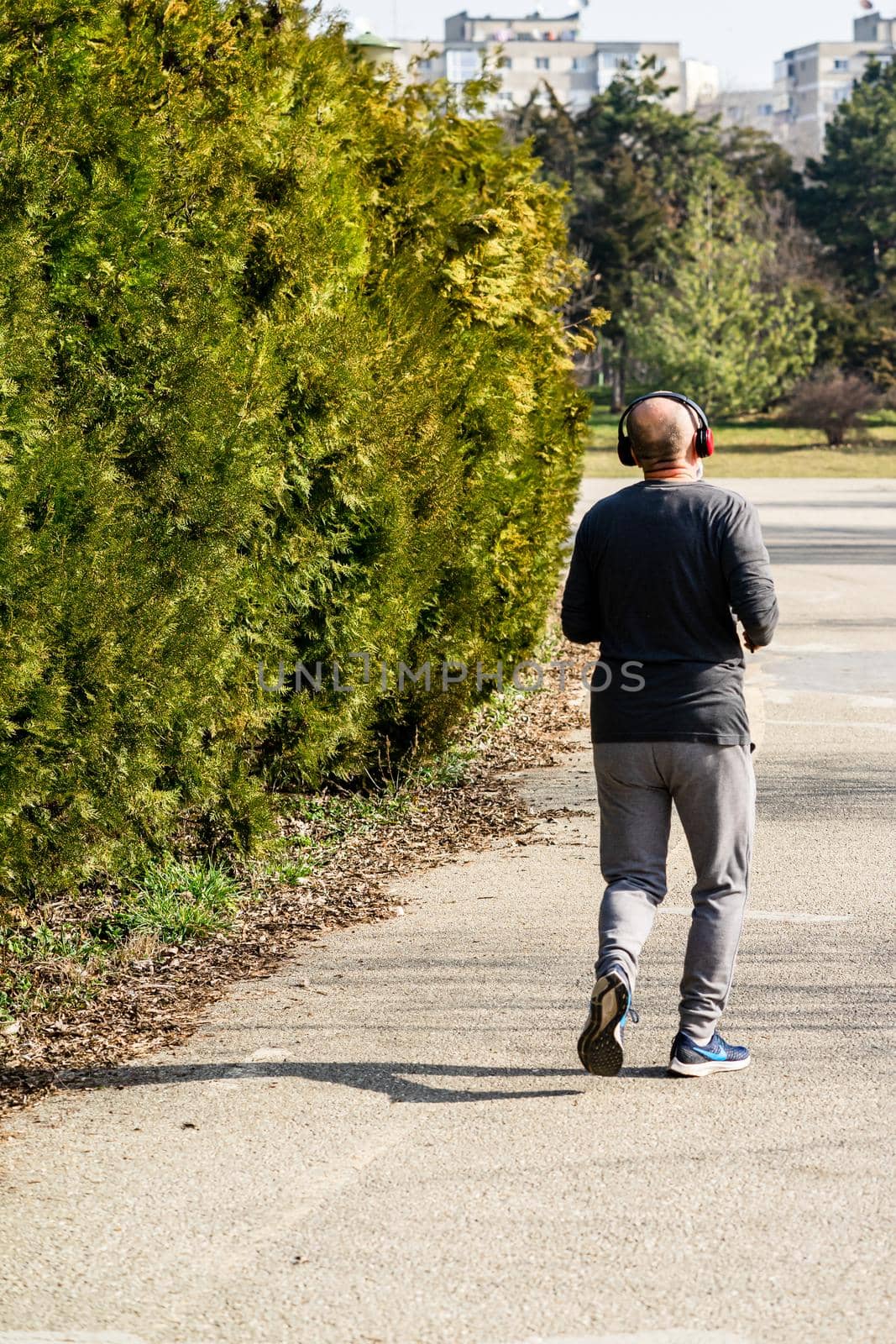 Jogging, running in the city park. Healthy lifestyle, outdoor physical activity and fitness concept in Bucharest, Romania, 2021