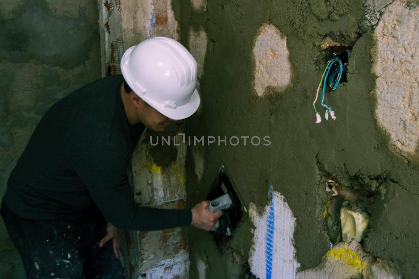 Man working on the reform of an apartment by xavier_photo