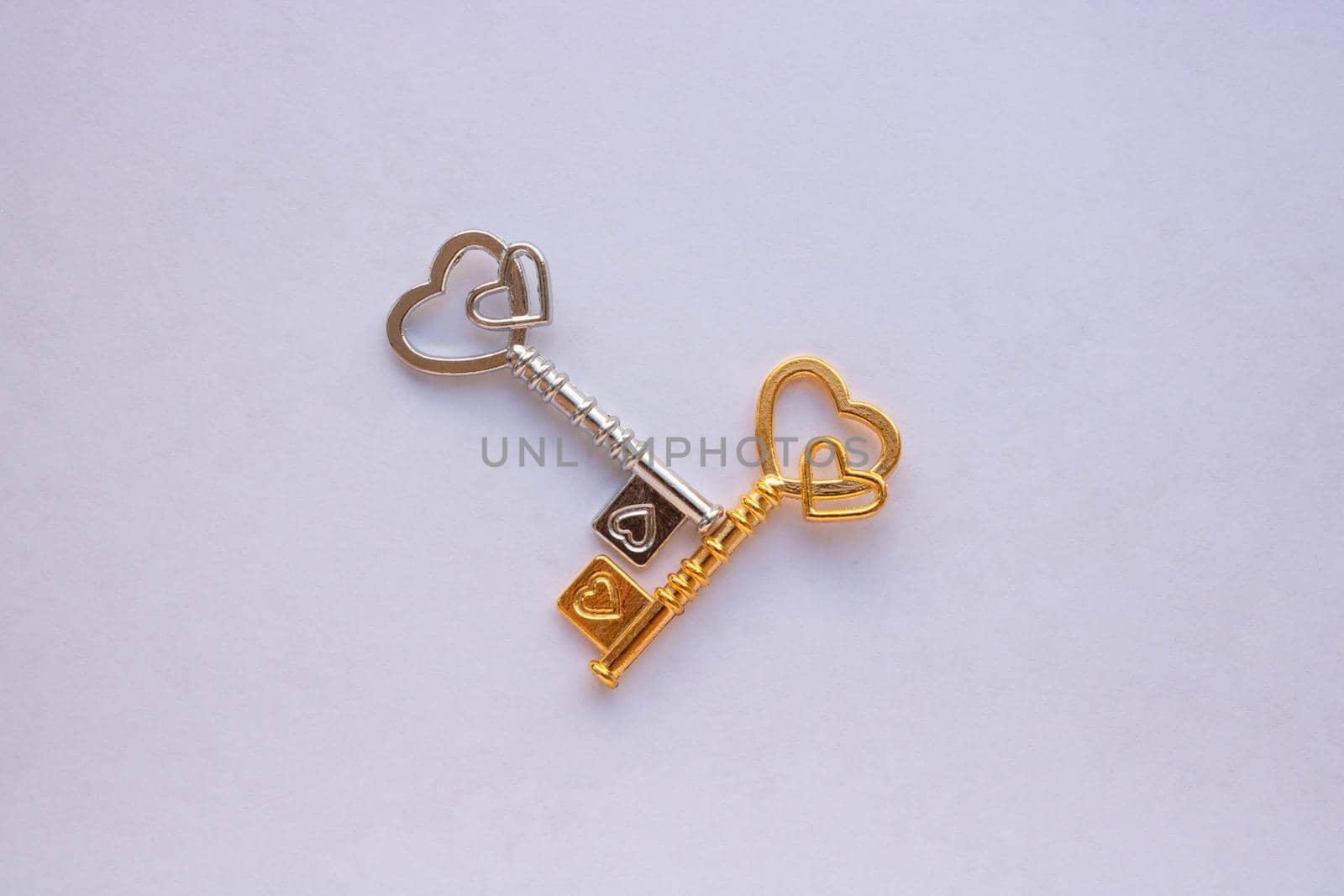 Gold and silver keys isolated on a white background.