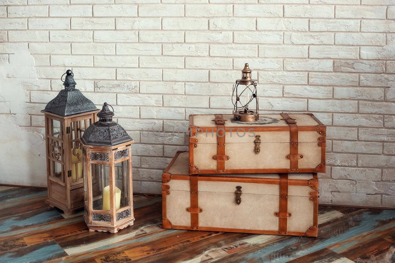 Decorative vintage suitcases and lamps against the background of a textured wall by galinasharapova