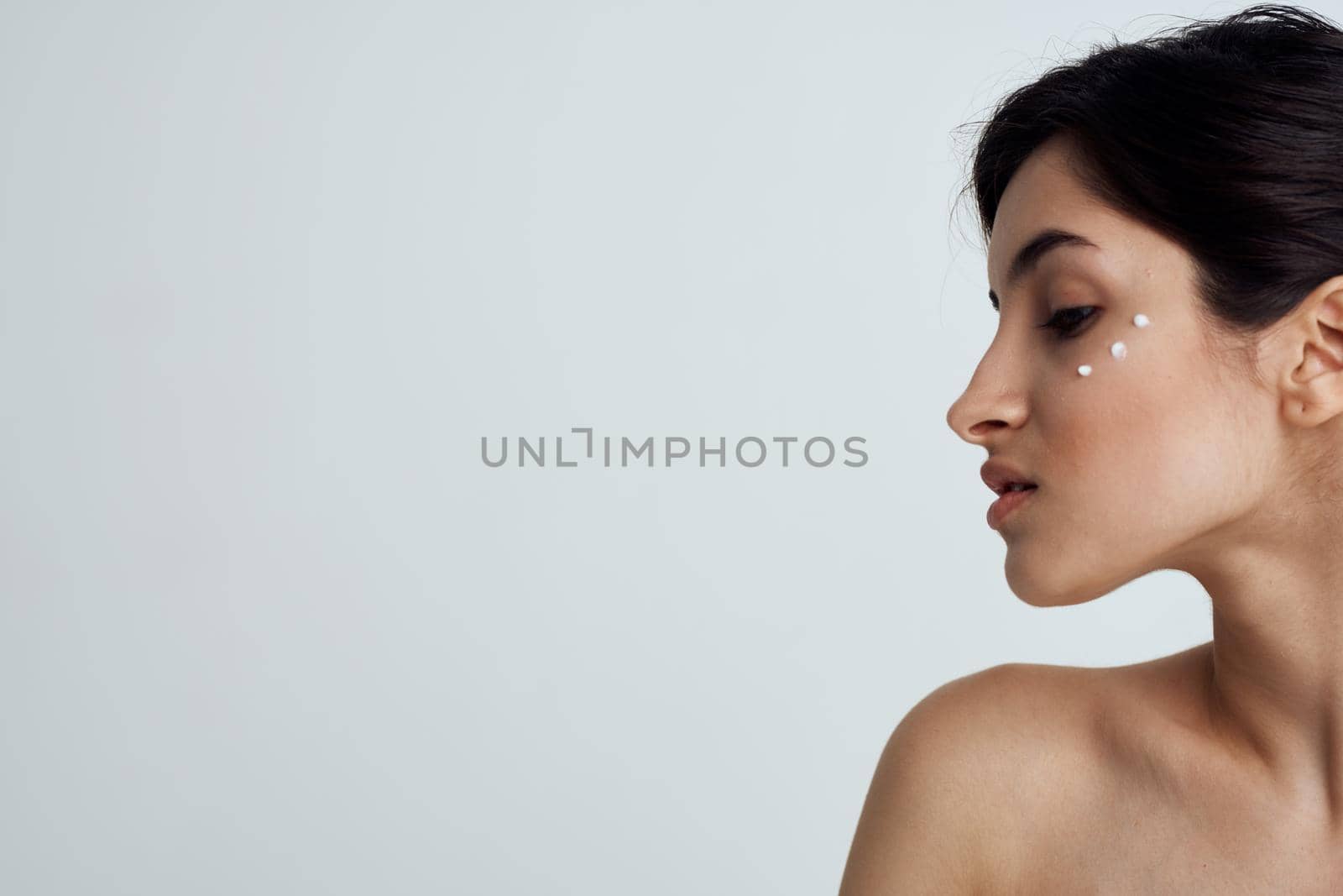 Pretty brunette naked shoulders skin care health hygiene. High quality photo