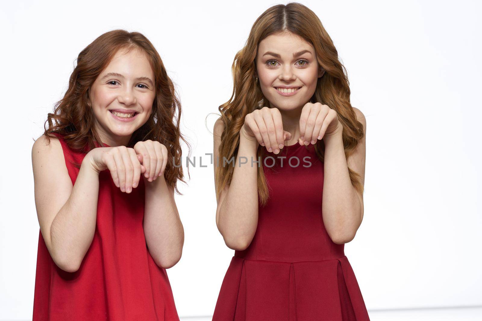 Cheerful mom and daughter hugs joy lifestyle family light background. High quality photo