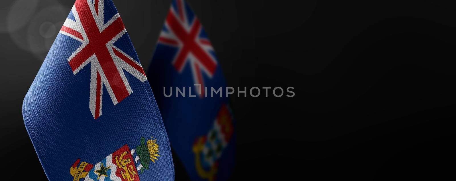 Small national flags of the Cayman Islands on a dark background.