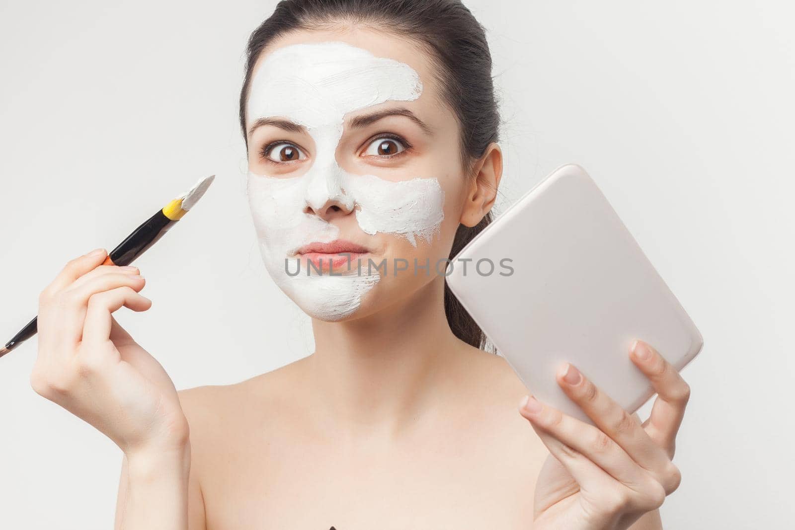 woman with bare shoulders brush in hands cosmetics skin care. High quality photo