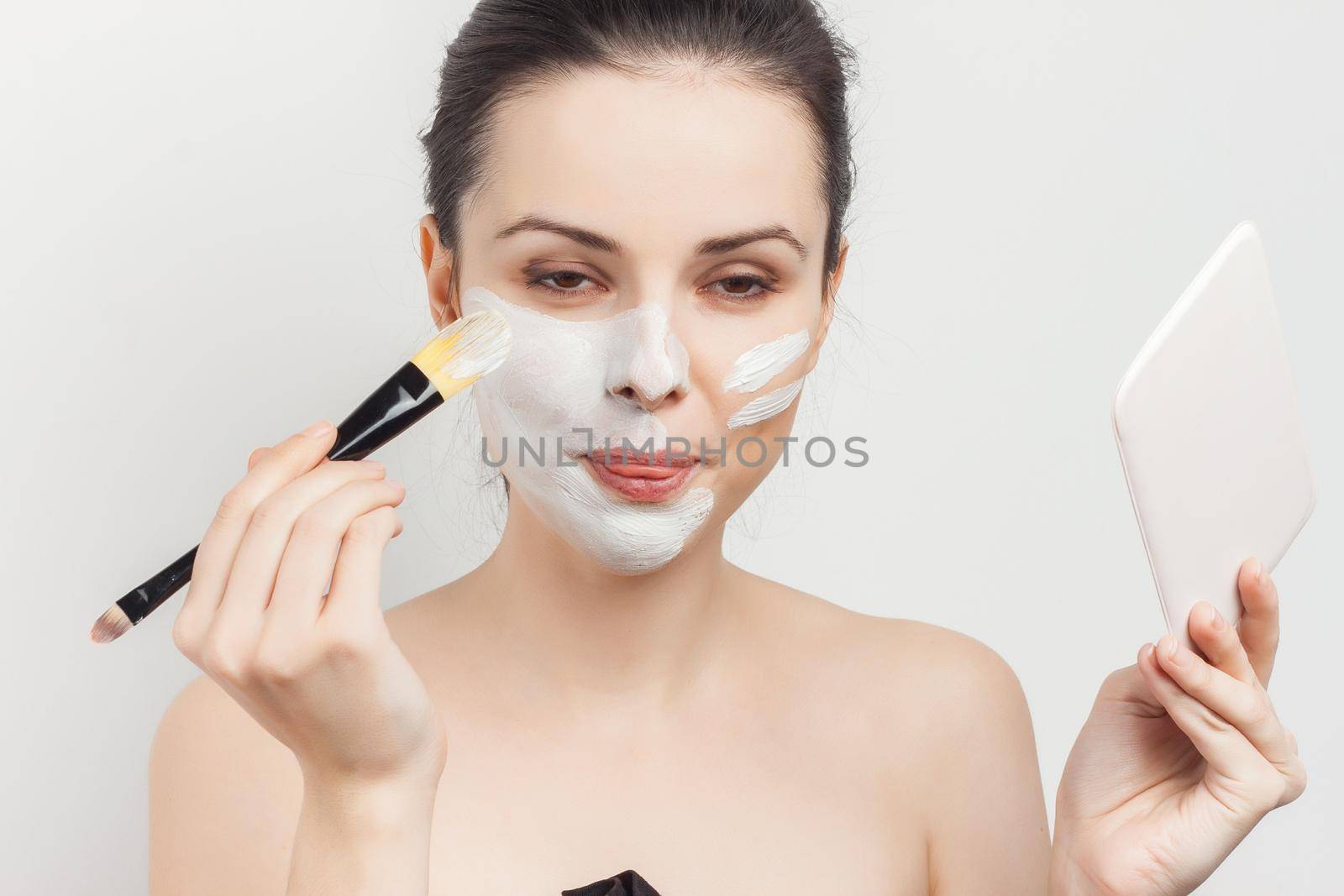 woman with face cream mask skin care naked shoulders spa treatments. High quality photo