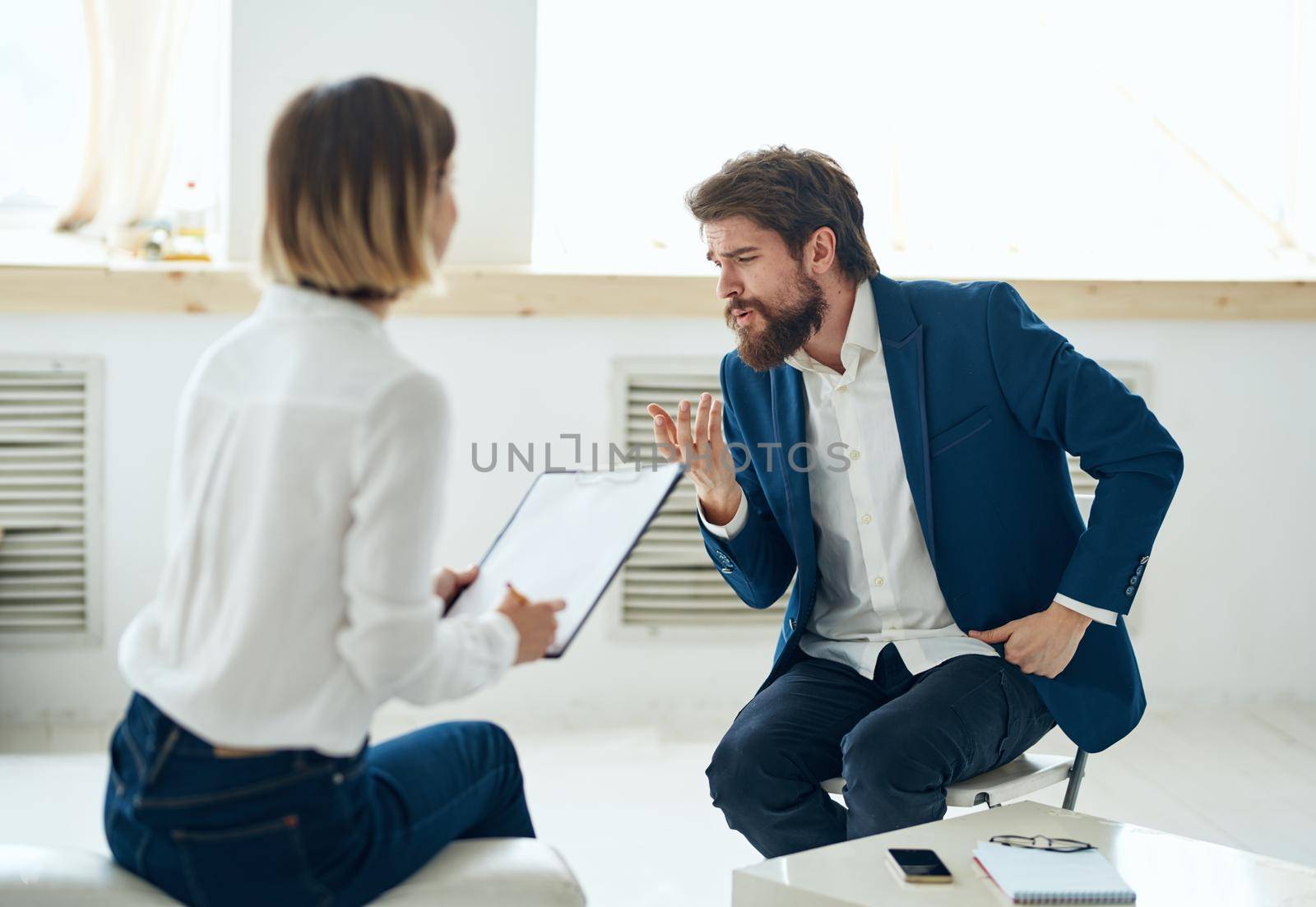 A man in a suit at a psychologist's office near the window. High quality photo