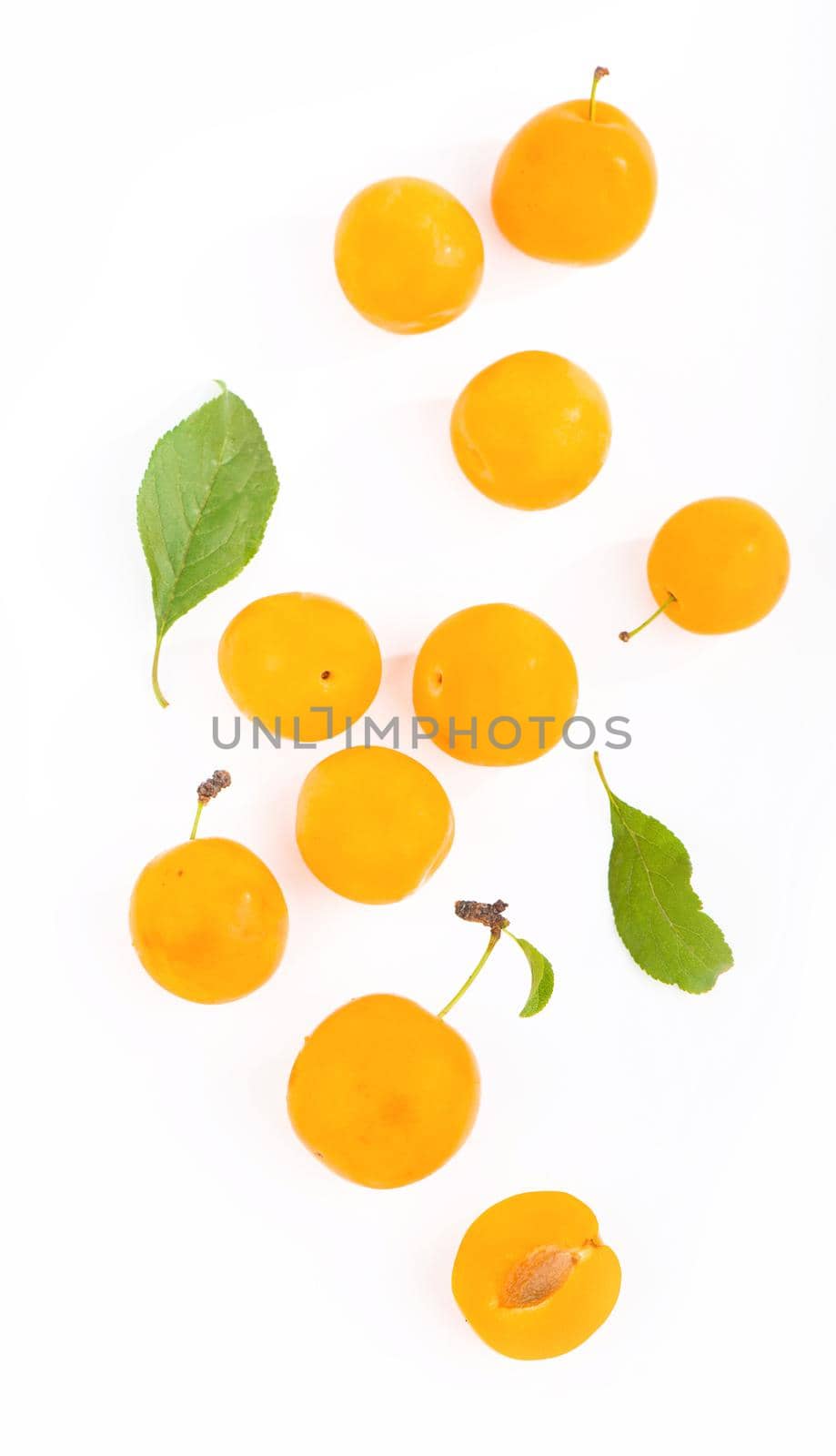 Yellow plum with leaves isolated on white background.