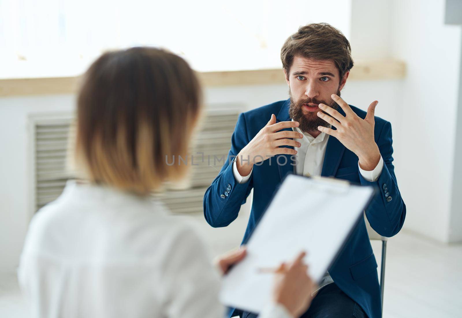 emotional man talking to psychologist professional consultation patient diagnosis. High quality photo