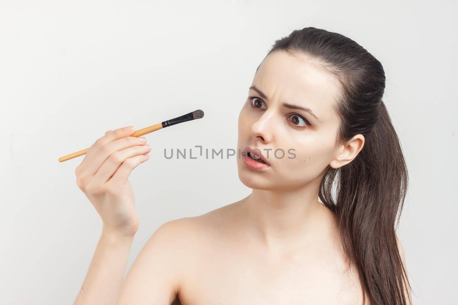 woman with bare shoulders brush in hands cosmetics skin care. High quality photo