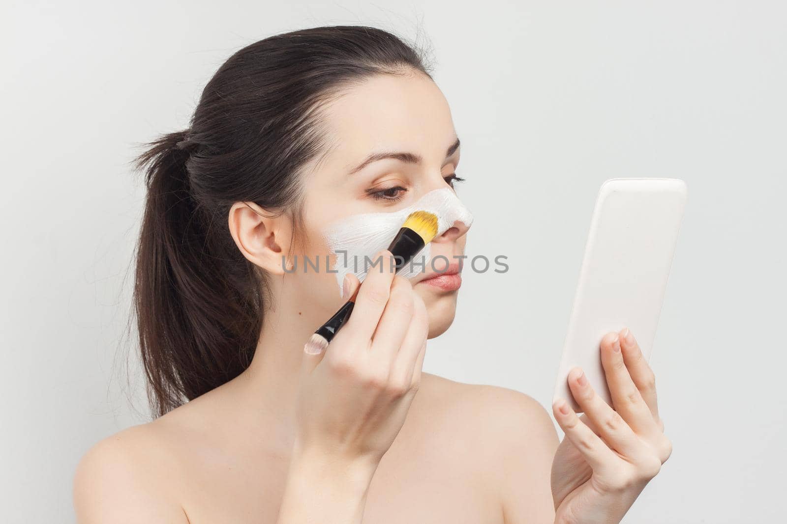 woman with bare shoulders brush in hands cosmetics skin care. High quality photo