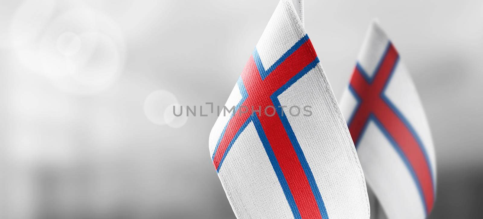 Patch of the national flag of the Faroe Islands on a white t-shirt.