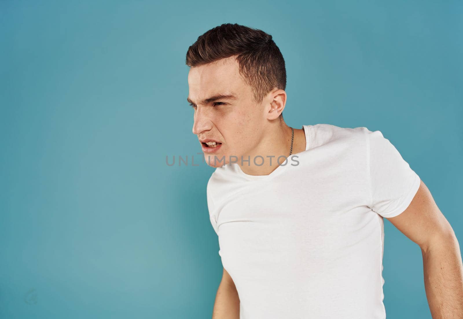 portrait of emotional man on blue background cropped view Copy Spac. High quality photo