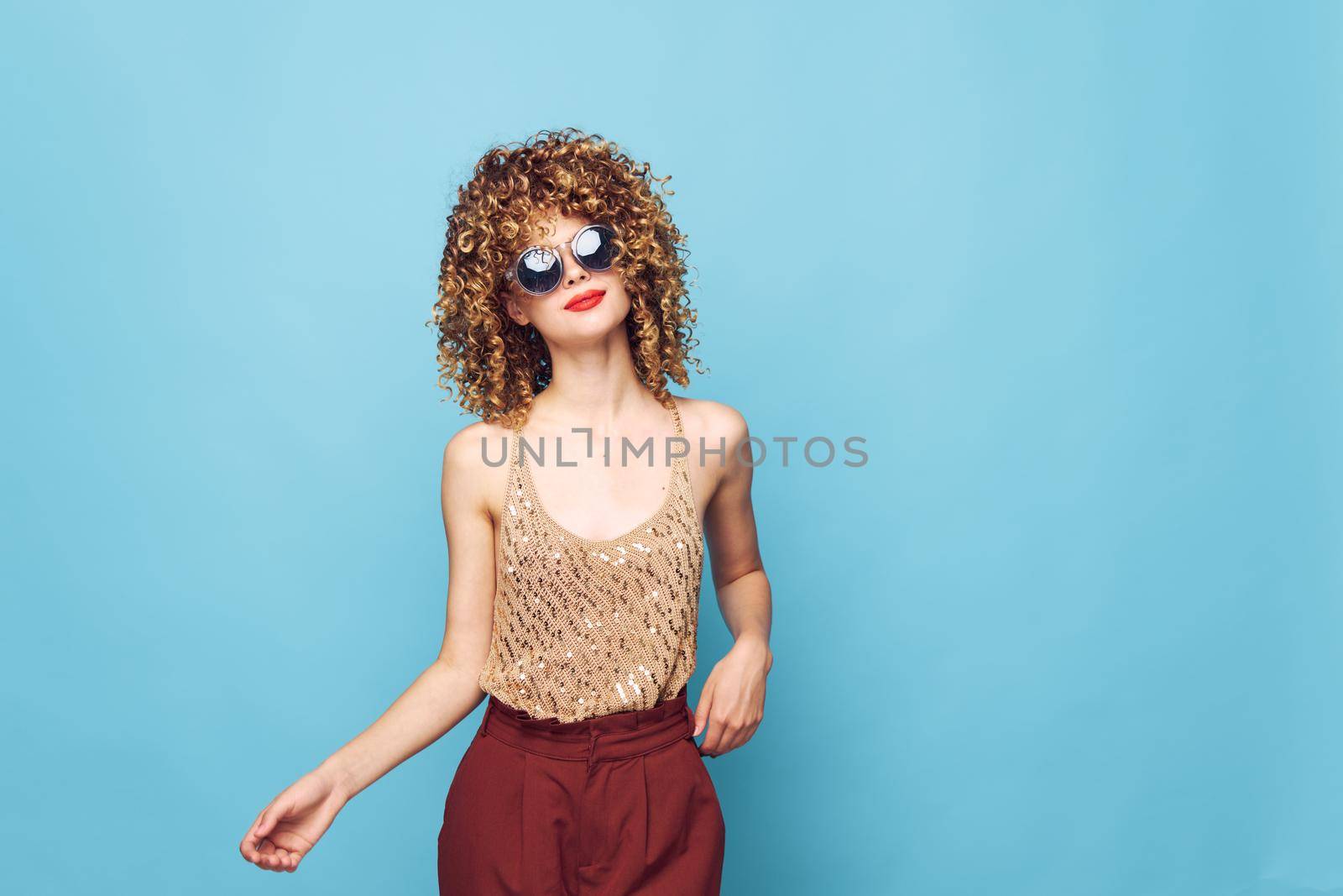 Beautiful woman Red lips curly hair fashionable clothes bright makeup cropped view