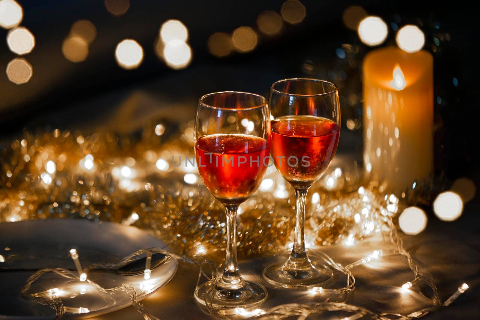 Celebration theme with  two red wine glass on  small gold light background by thanumporn