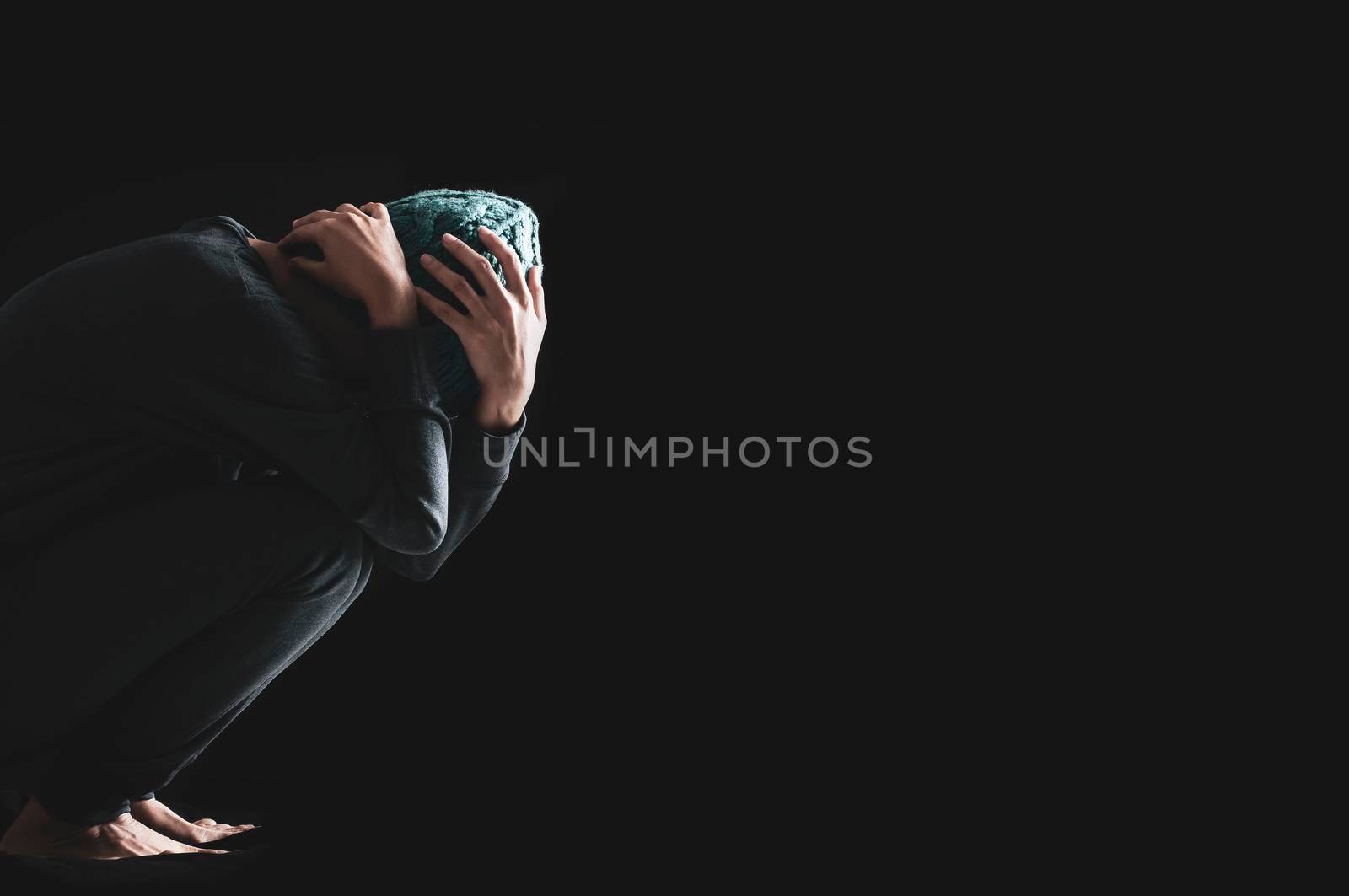 Asia Woman with depression sitting alone on the floor in the dark room, Black and white photo