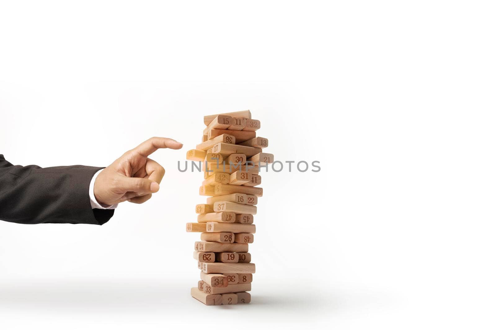 Business risks in the business. Requires planning Meditation must be careful in deciding to reduce the risk in the business. As the game businessman and engineer gambling placing wooden block on a tower.