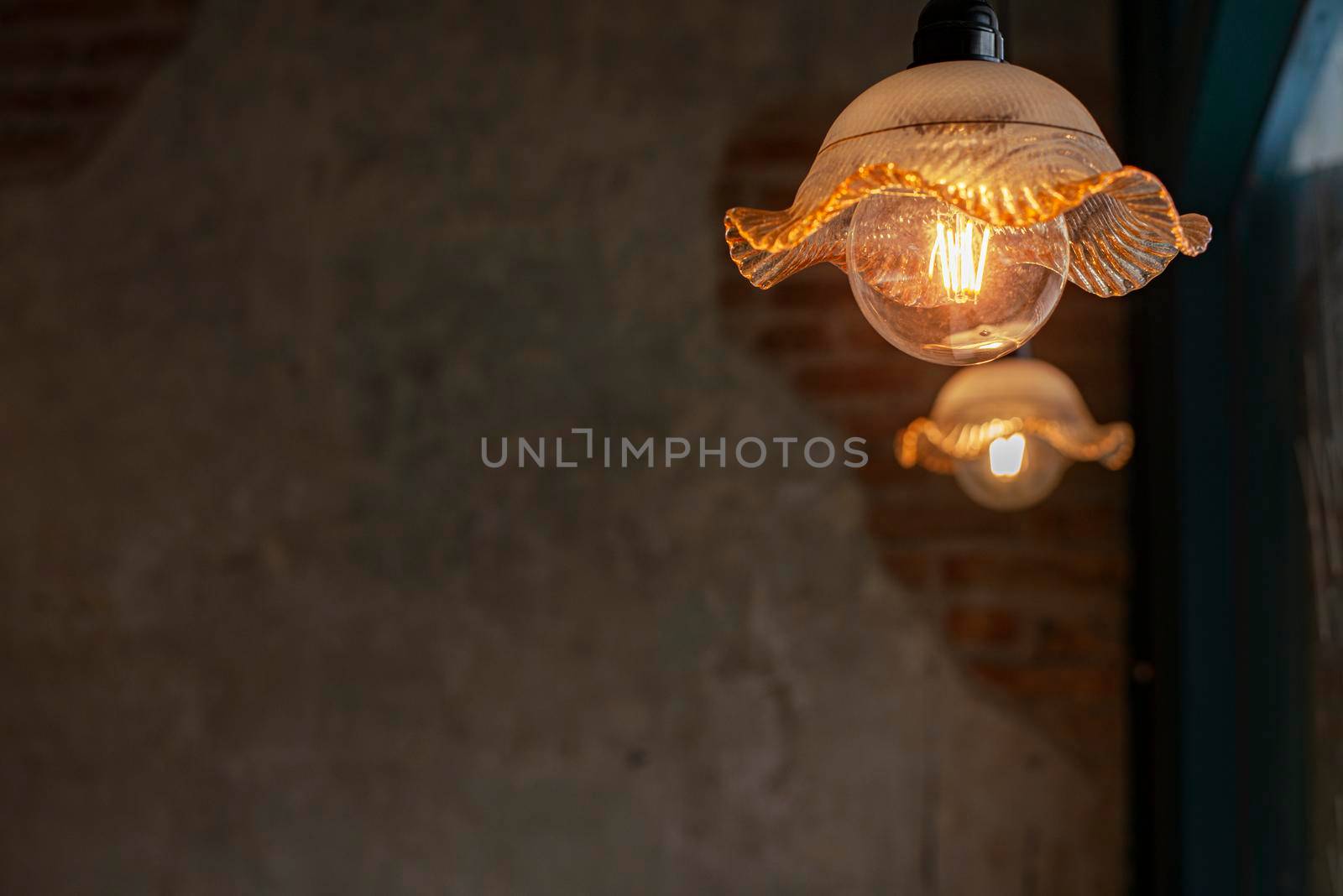 Retro yellow lanterns on the old wall background Is a vintage style decoration, creative ideas, lamps, design, modern interior items by thanumporn