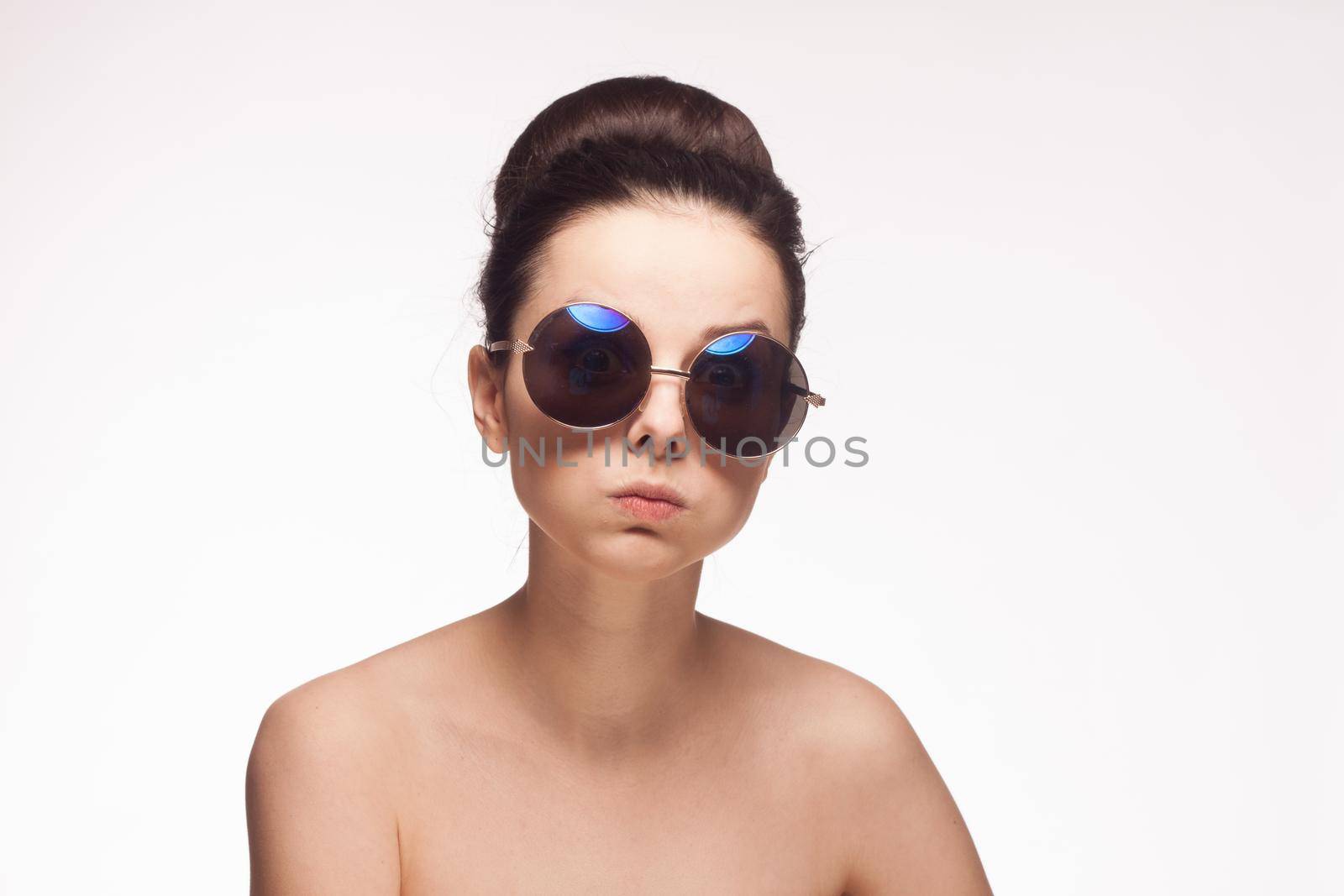 woman wearing sunglasses cropped view emotion light background. High quality photo