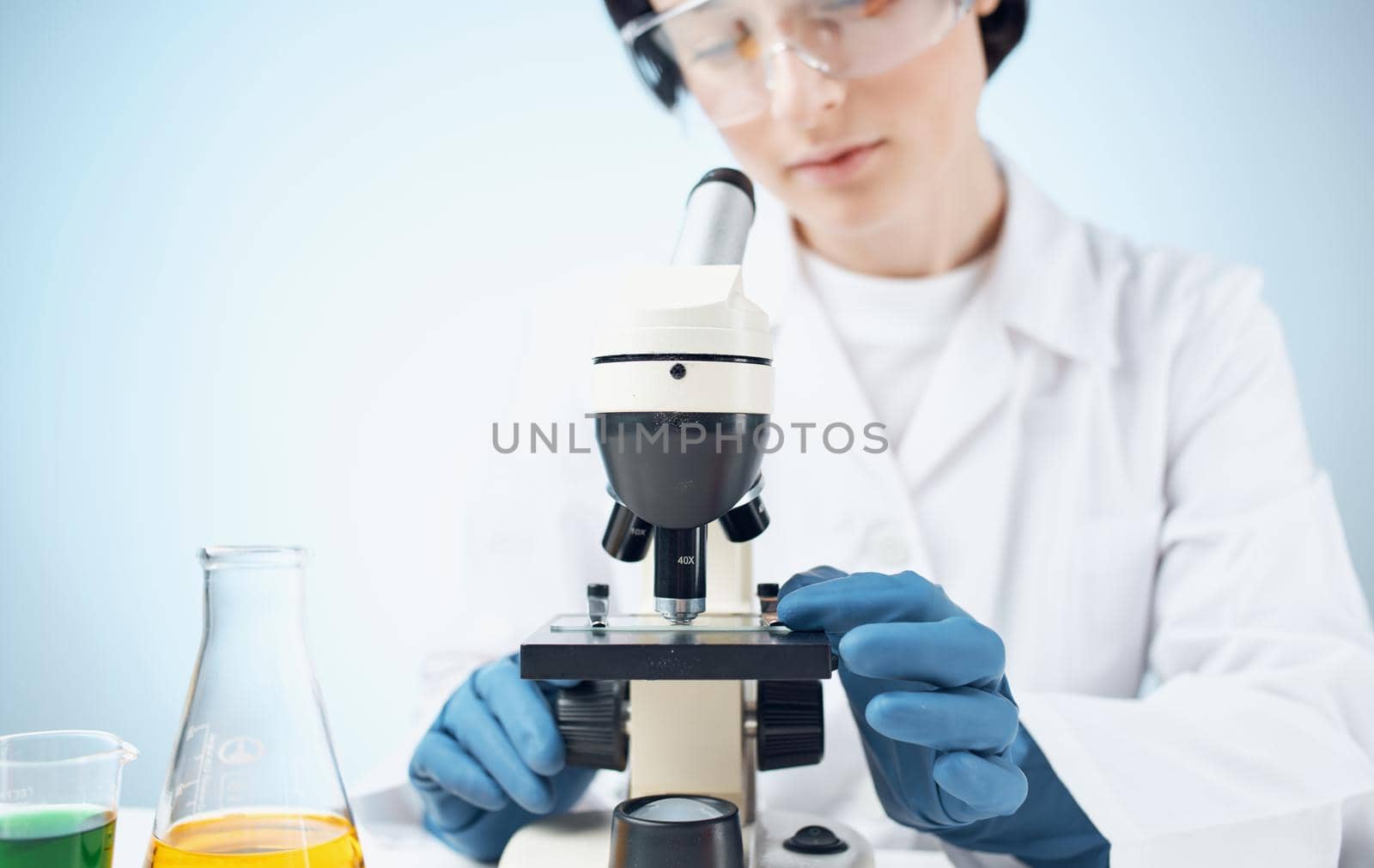 doctor in a medical gown vaccination flask liquid laboratory research bacteria. High quality photo