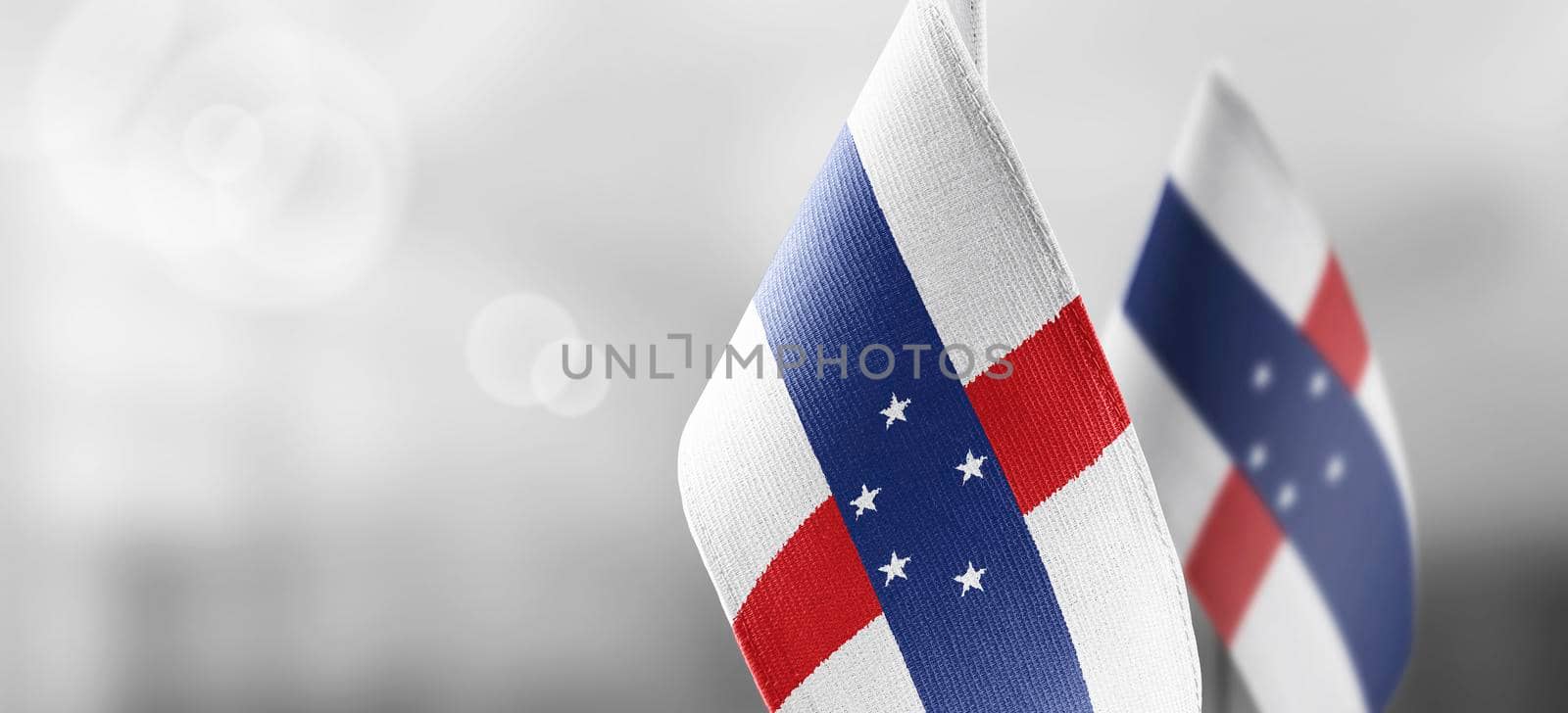 Patch of the national flag of the Netherlands Antilles on a white t-shirt.