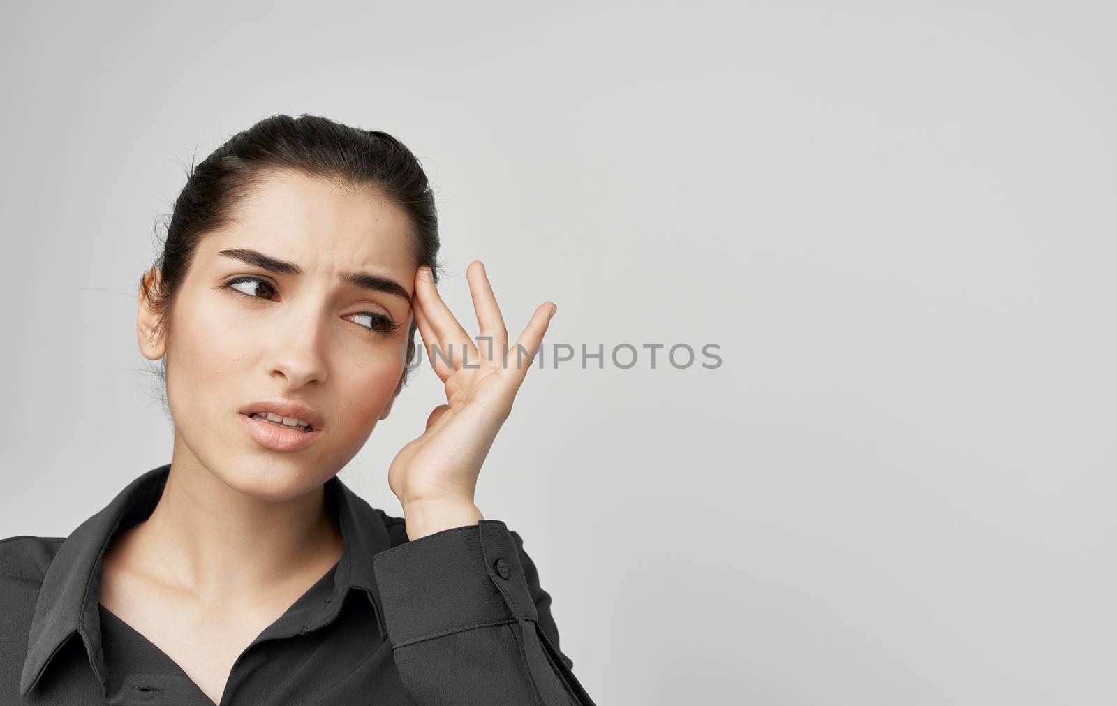 brunette in shirt holding face health problems discontent. High quality photo