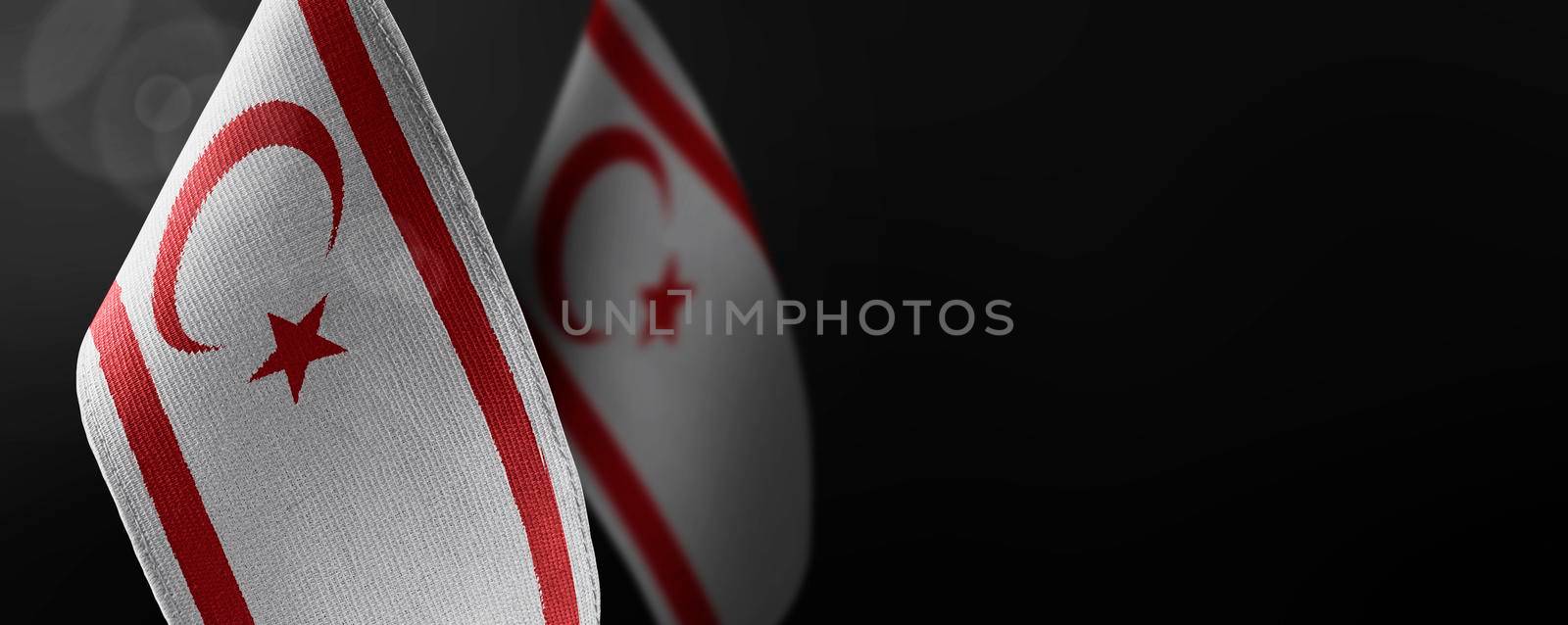 Small national flags of the Northern Cyprus on a dark background.