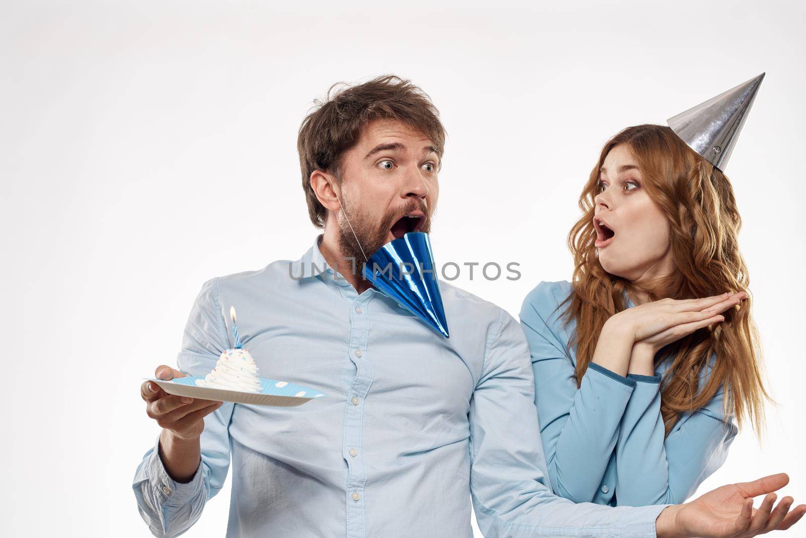man and woman birthday celebration in hats on the head fun. High quality photo