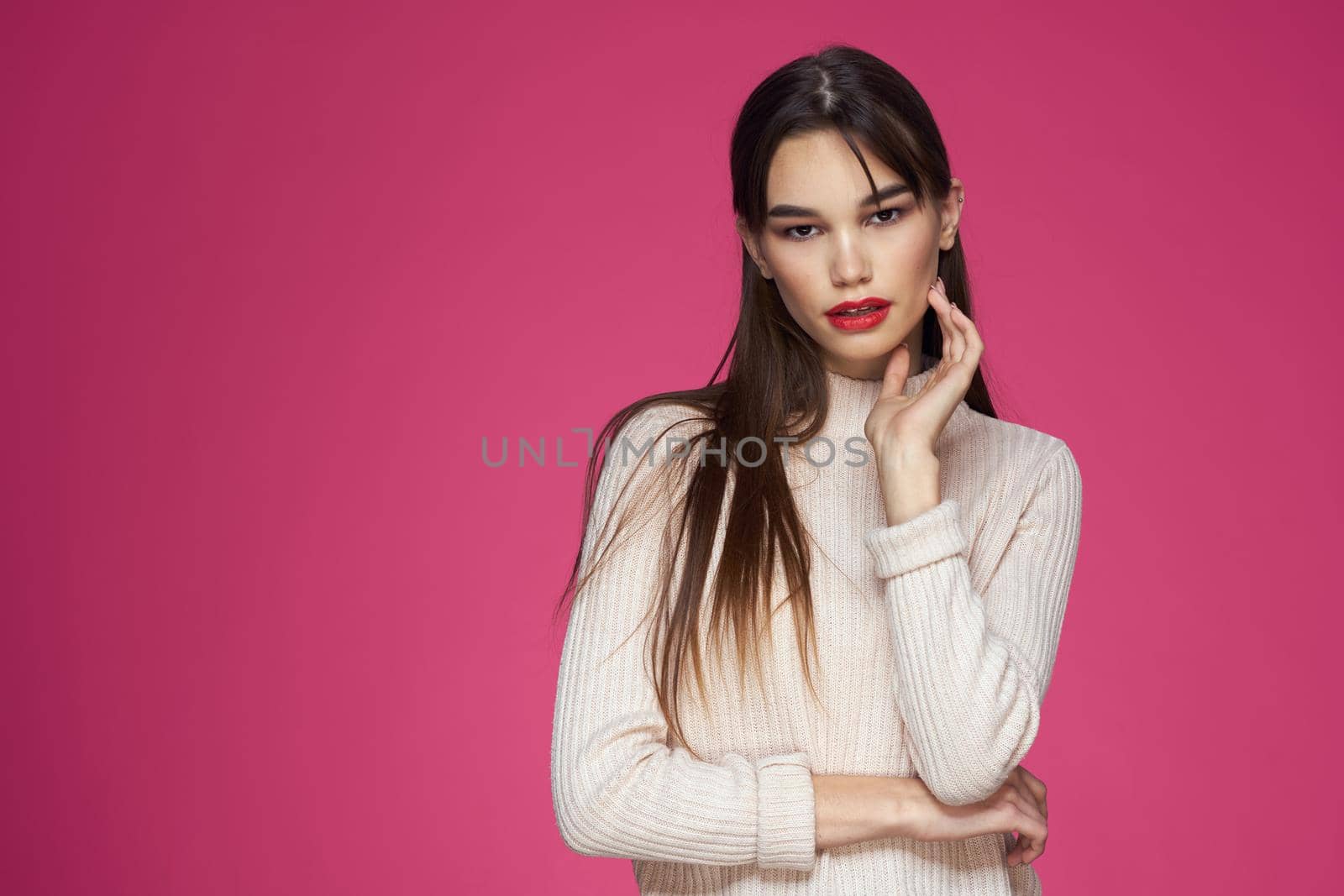 Cute brunette red lips glamor cosmetics pink background. High quality photo