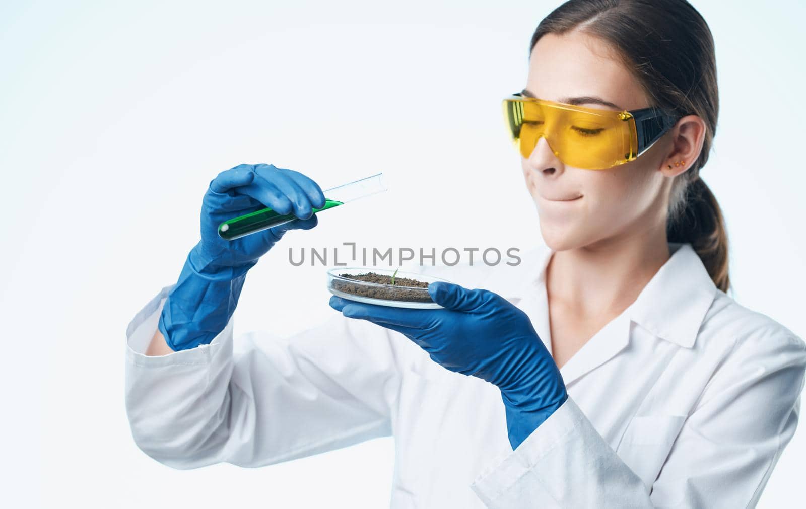 woman doctor in medical gloves and in a white medical coat holds flasks in her hands documents. High quality photo