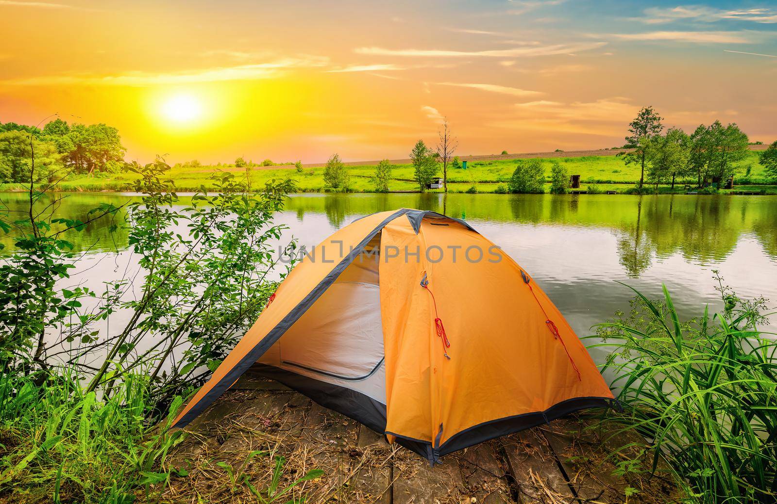 Tent and calm river in the morning