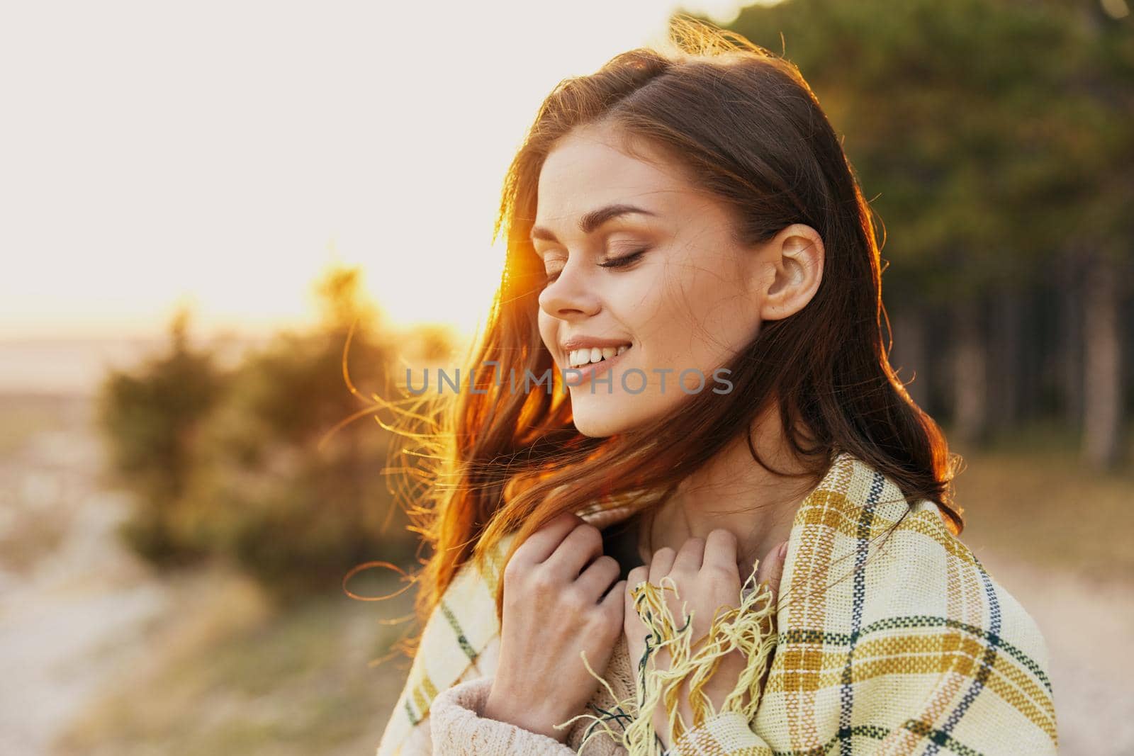 happy woman with red hair at sunset near the forest. High quality photo