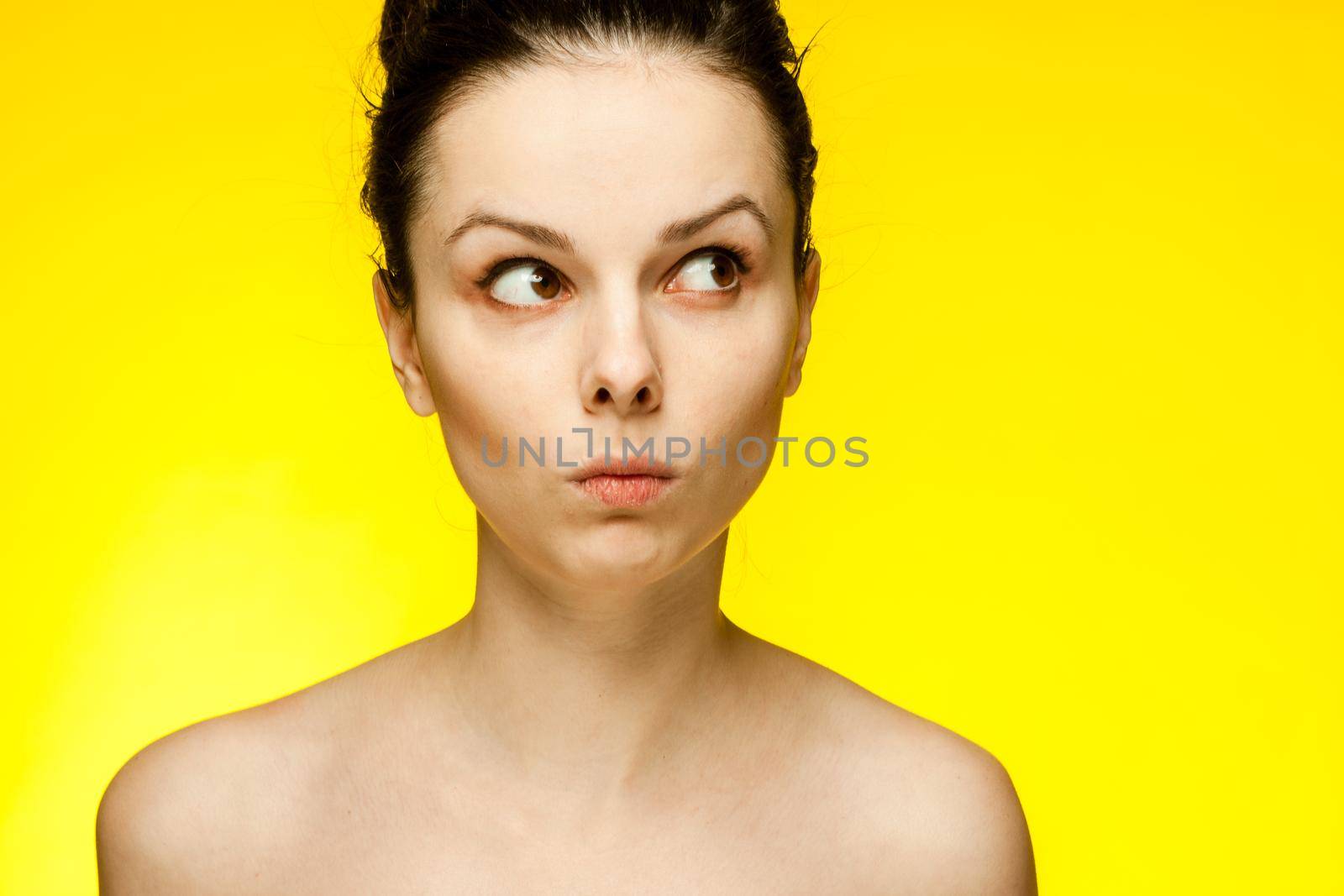 pretty woman with bare shoulders emotions fashionable yellow glasses cropped view. High quality photo