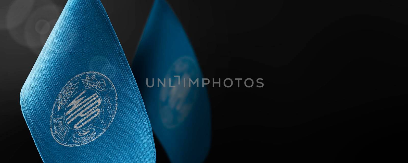 Small national flags of the International Intellectual Property Organization on a dark background by butenkow