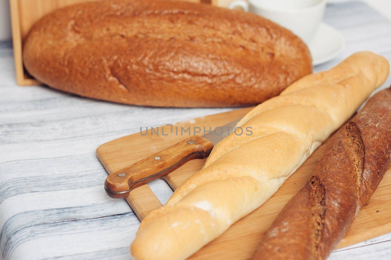 fresh loaves on a breadbasket on the table breakfast . High quality photo