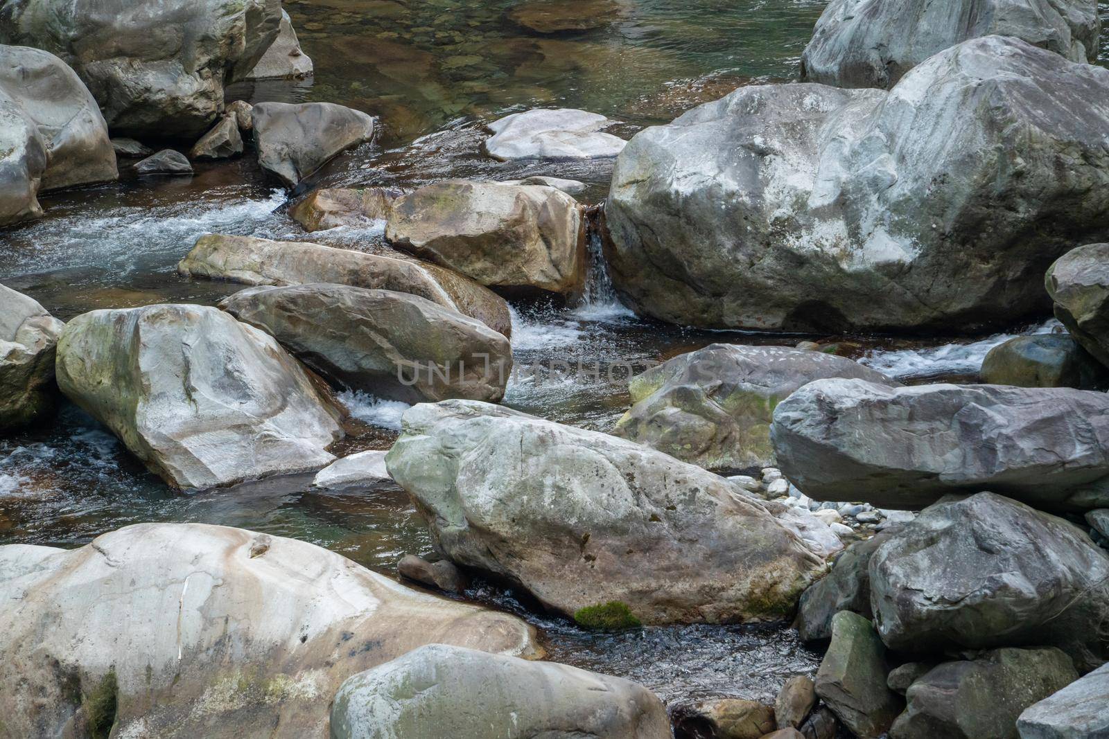 Wild river flow in forest with rock stones landscape in Taiwan.
