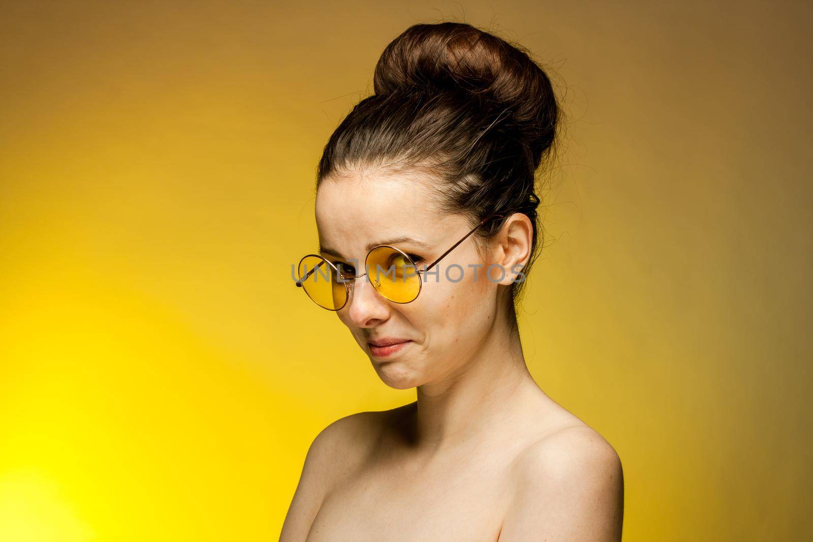 woman in yellow glasses naked shoulders gestures with hands by SHOTPRIME