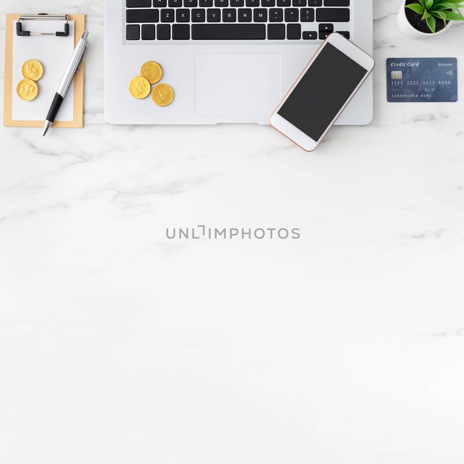 Top view of financial plan concept with credit card, laptop, note on white office table background.
